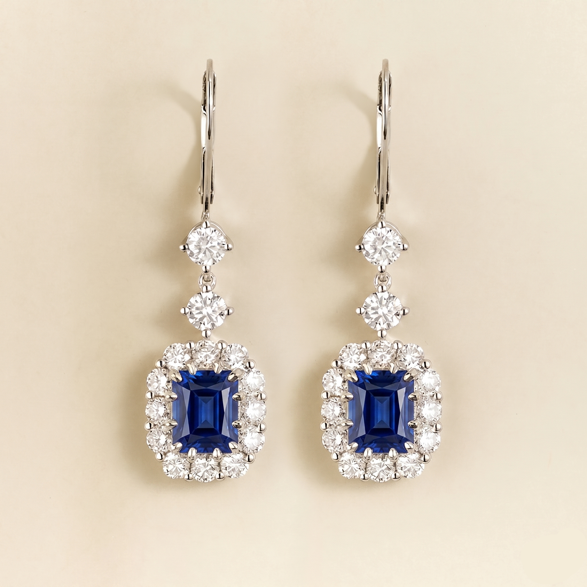 Emerald-cut lab-grown blue sapphire and diamond halo dangle drop earrings, Pippa design in white gold | Juvetti London