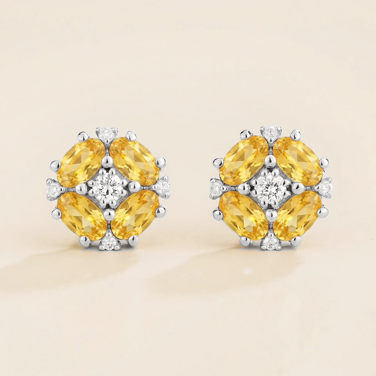 Pristi oval yellow sapphire & diamond flower cluster stud earrings in white gold – front view | Juvetti