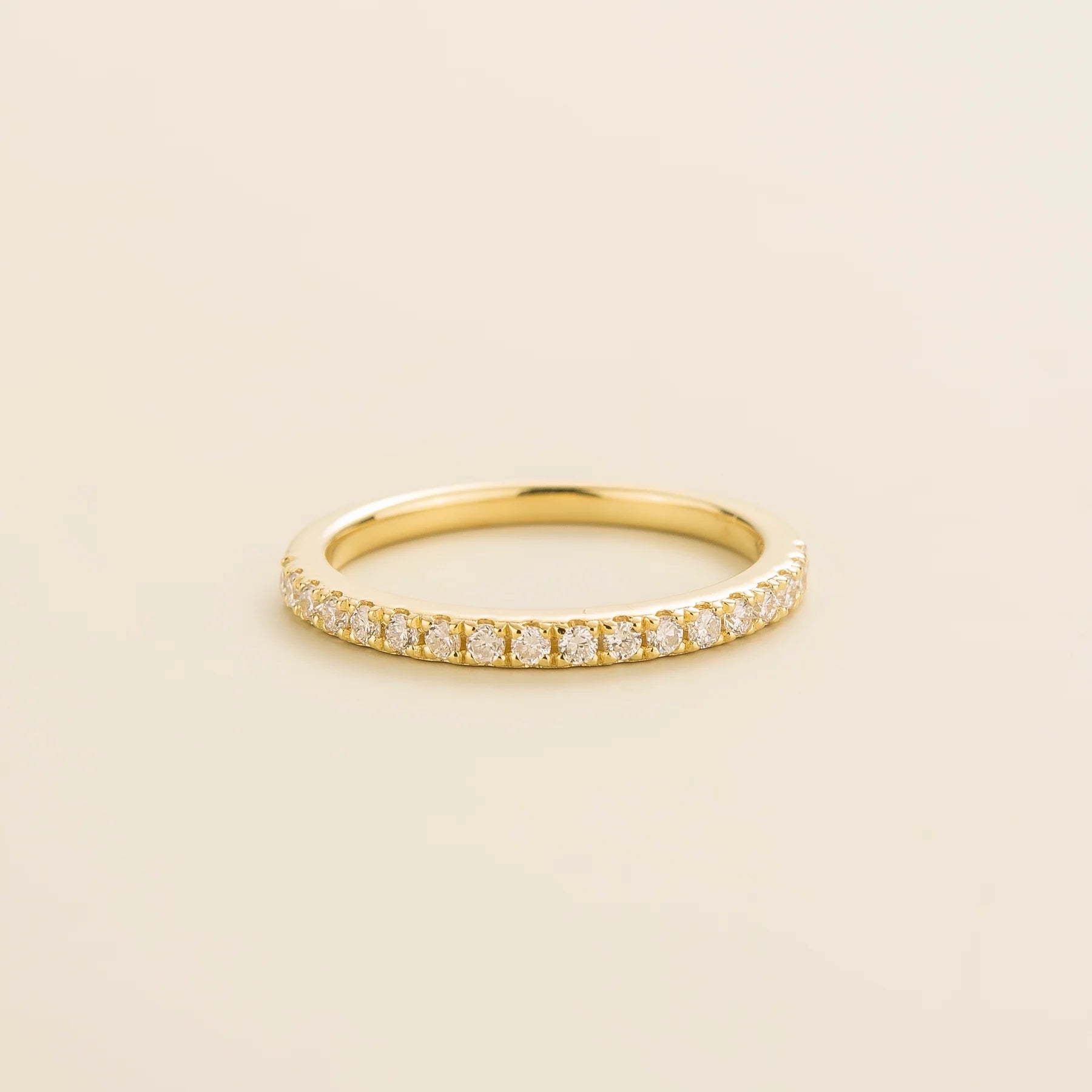 Juvetti yellow gold half eternity band set with round lab-grown diamonds.