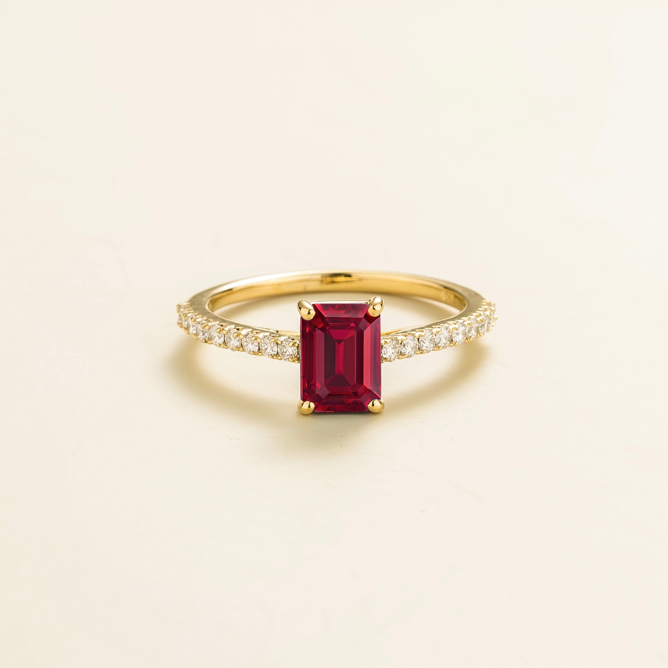 Juvetti gold fine jewellery ring with lab-grown ruby emerald cut and round lab-grown diamond band.