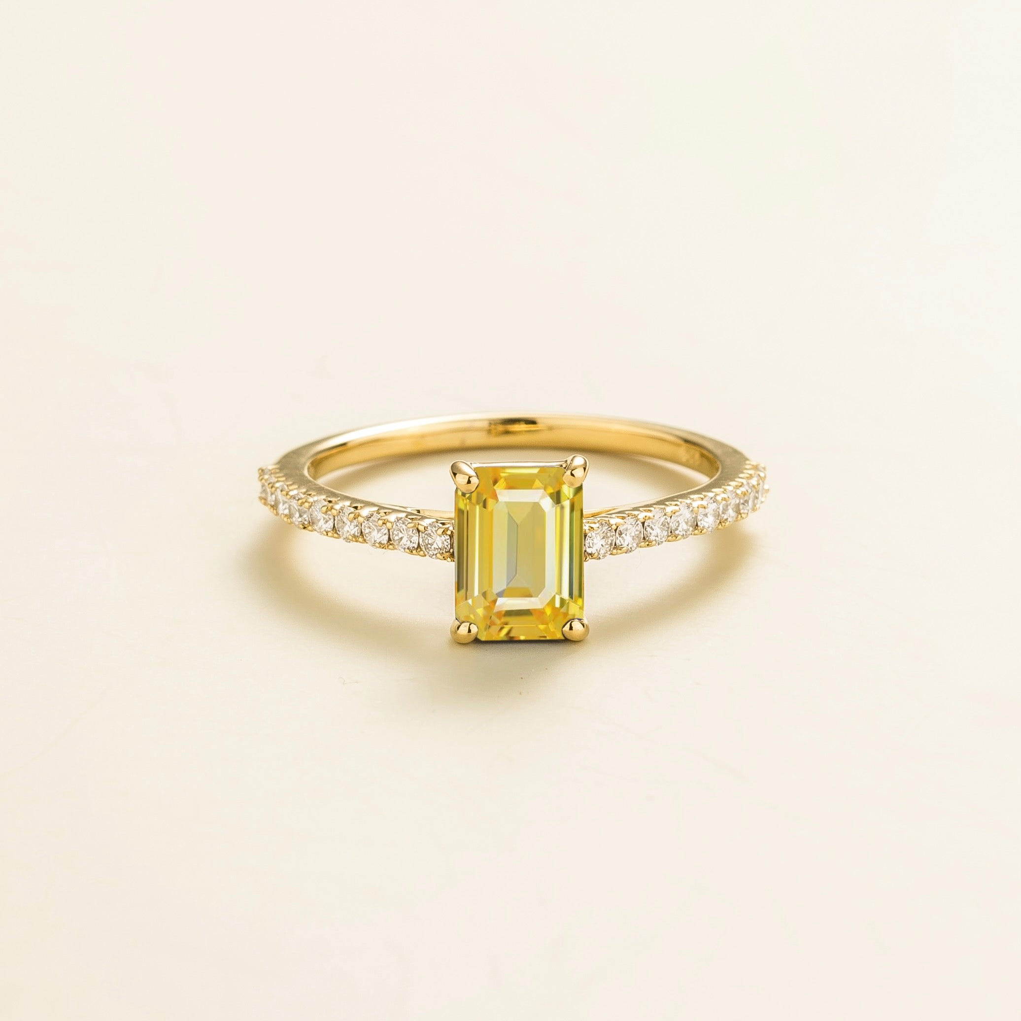 Juvetti gold fine jewellery ring with lab-grown yellow sapphire emerald cut and round lab-grown diamond band.