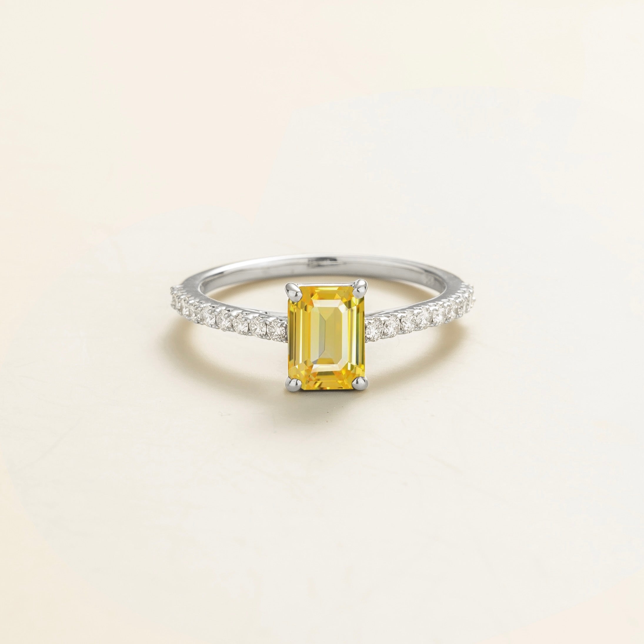 Juvetti white gold fine jewellery ring with lab-grown yellow sapphire emerald cut and round lab-grown diamond band.