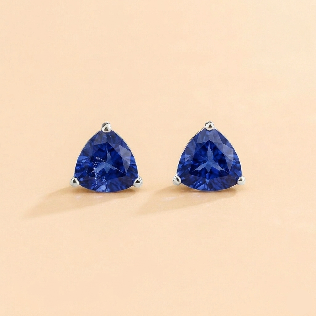 Trillion-cut lab-grown blue sapphire solitaire stud earrings in white gold | Juvetti London