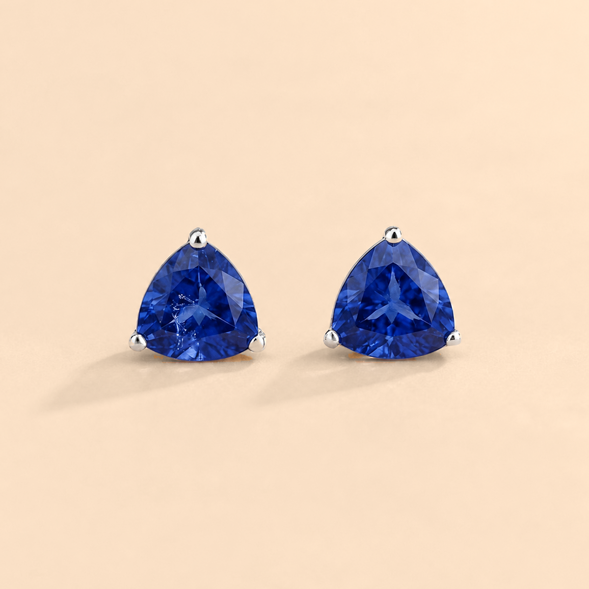 Trillion-cut lab-grown blue sapphire solitaire stud earrings in white gold | Juvetti London