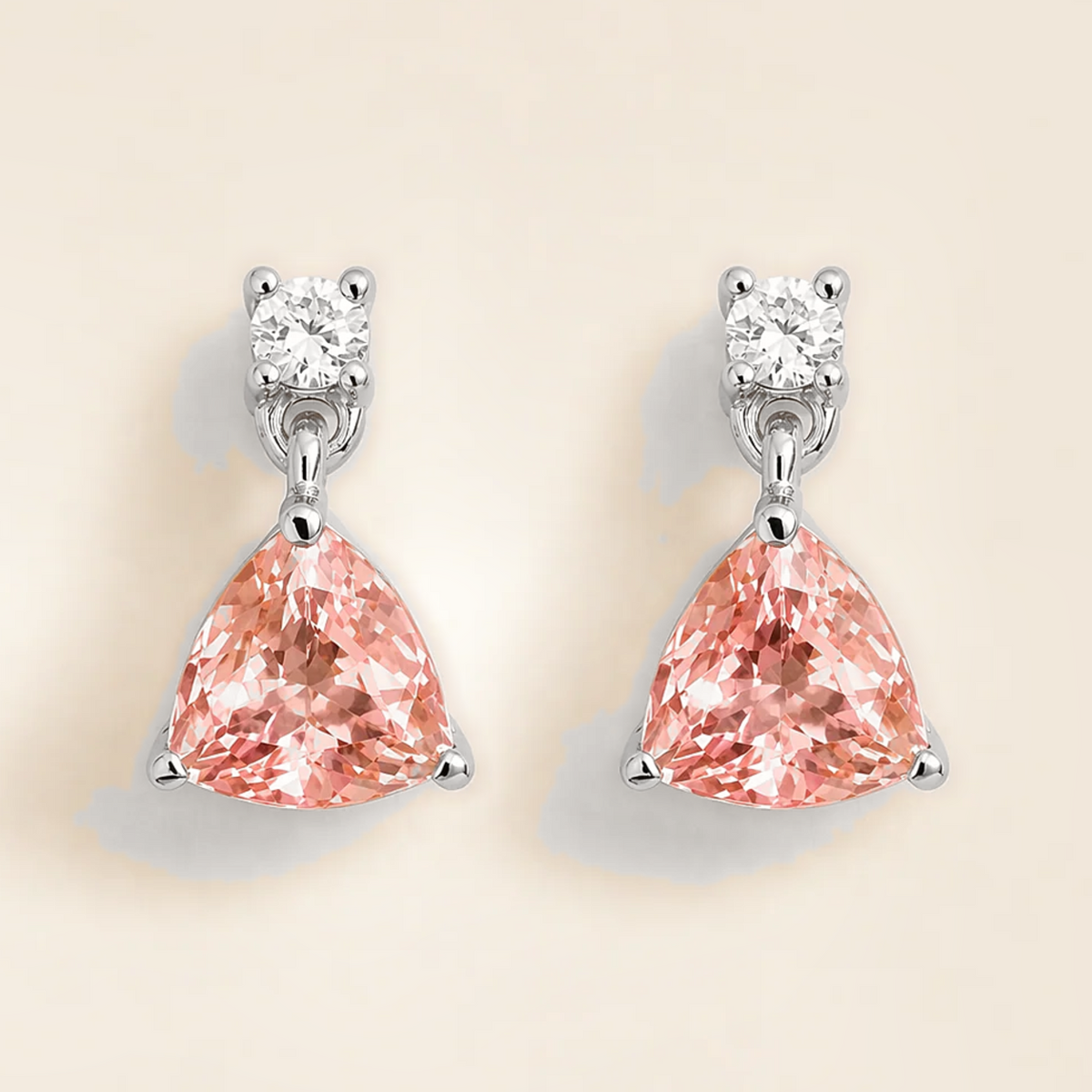 Trillion-cut lab-grown padparadscha sapphire and diamond drop earrings in white gold | Juvetti London