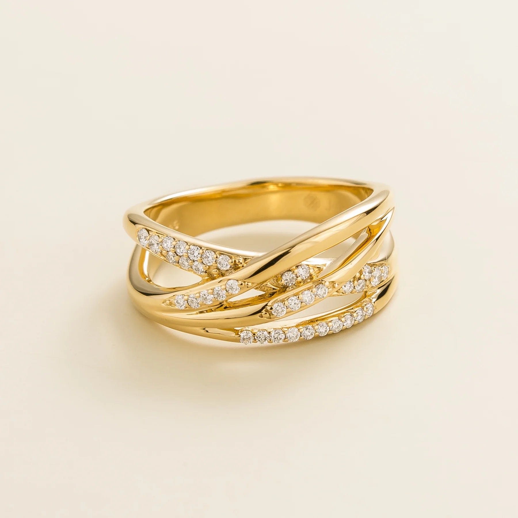 Juvetti yellow gold crossover ring set with round lab-grown diamonds.