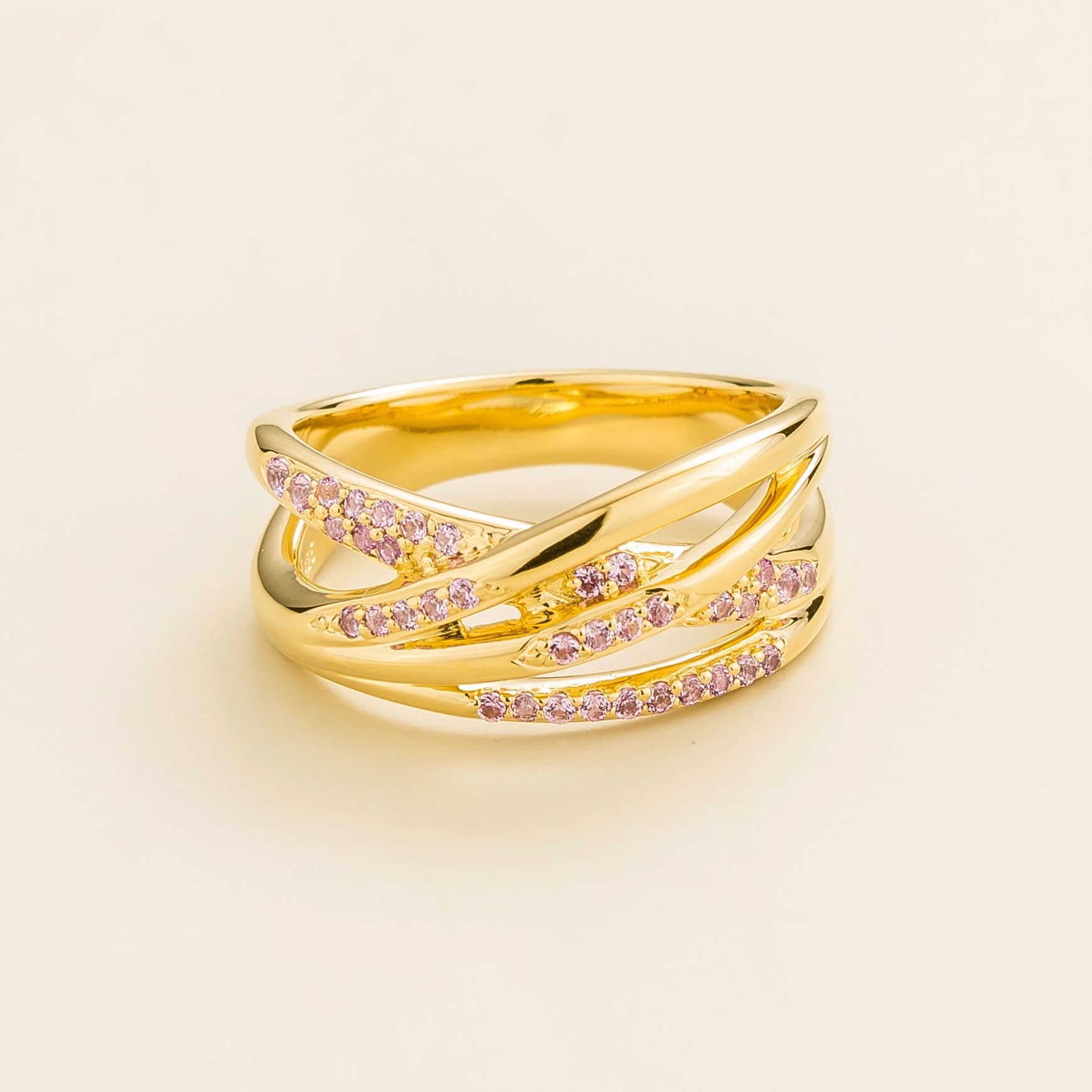 Juvetti yellow gold crossover ring set with round lab-grown pink sapphires.