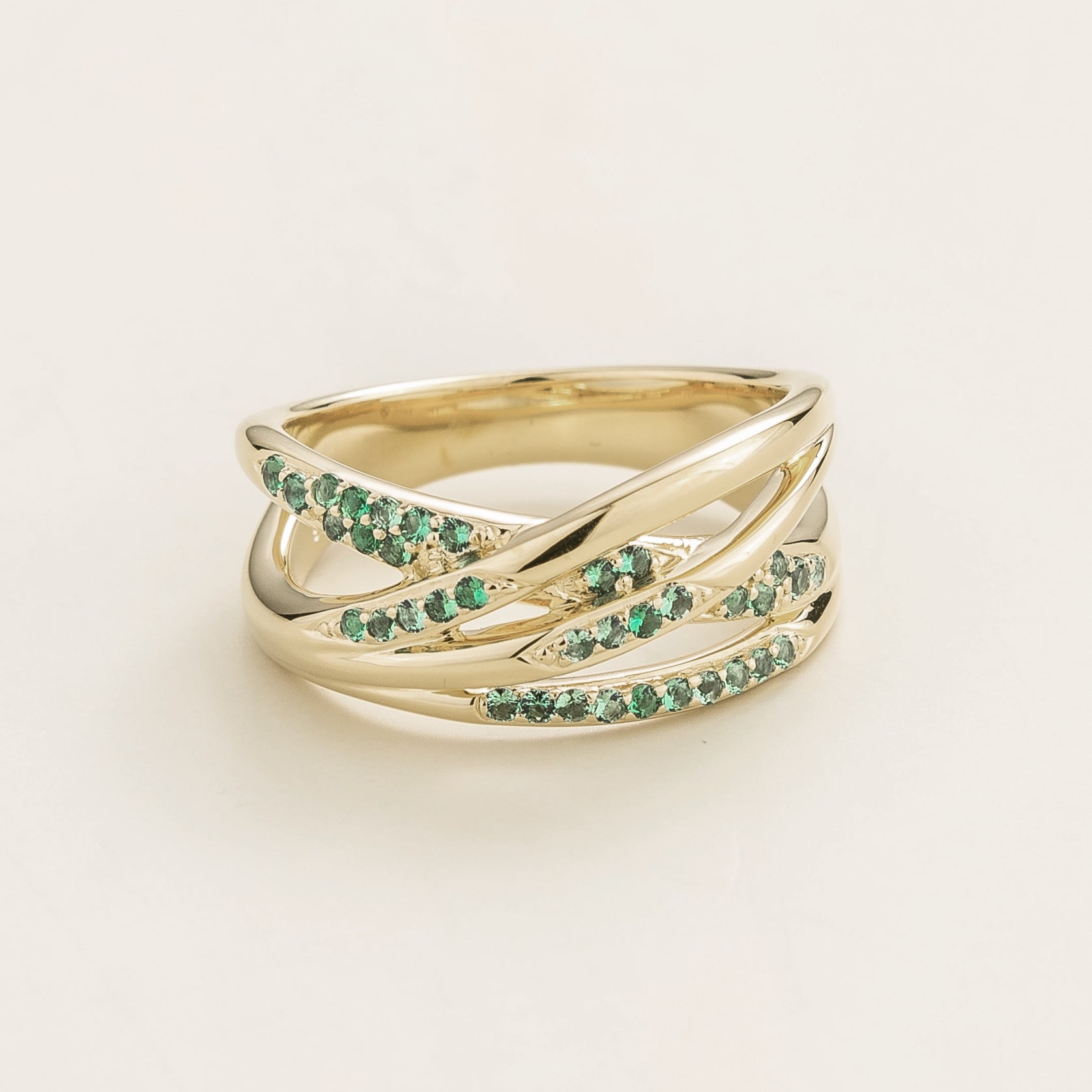 Juvetti white gold crossover ring set with round lab-grown emeralds.
