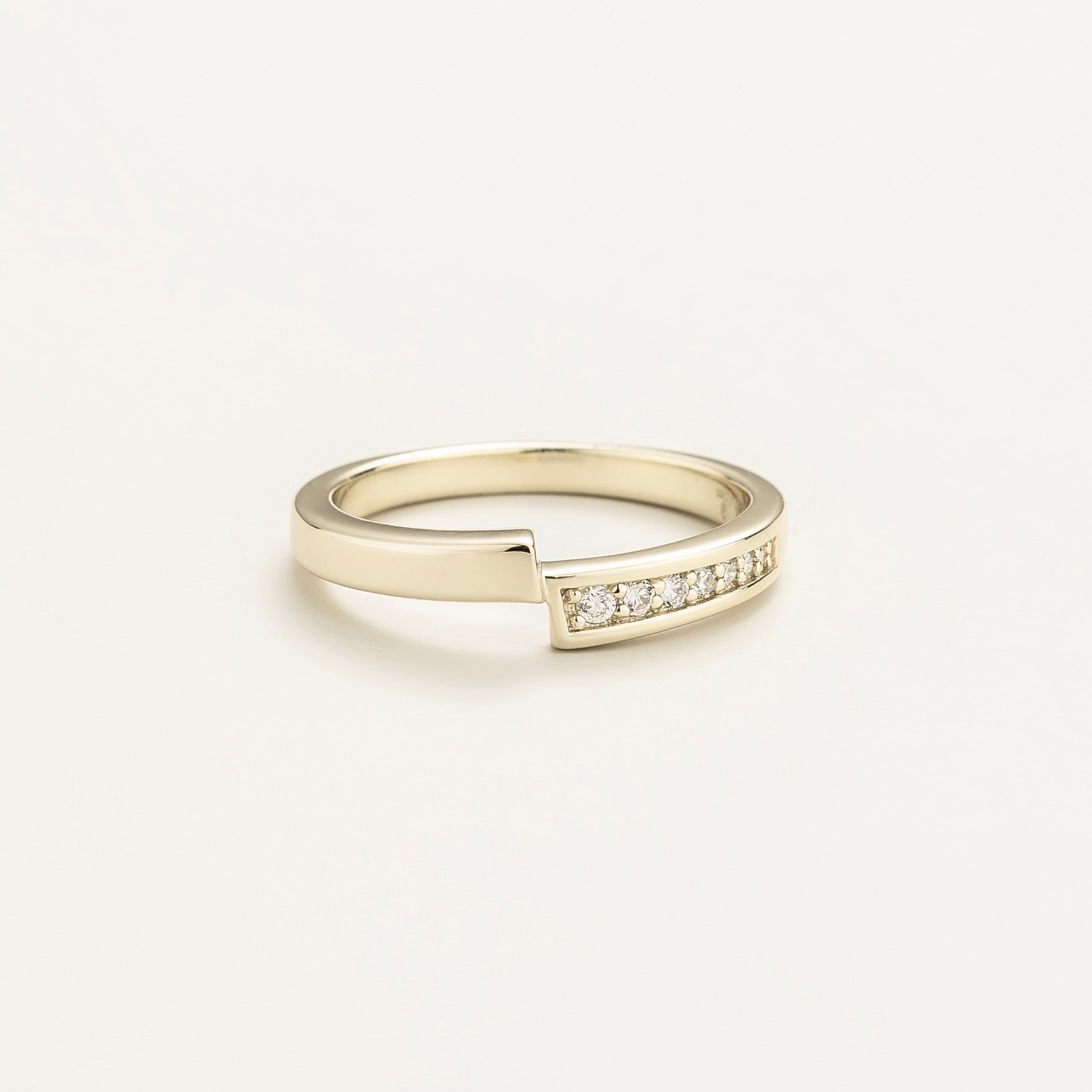 Elegant modern white gold ring featuring offset band and pavé-set lab-grown diamonds
