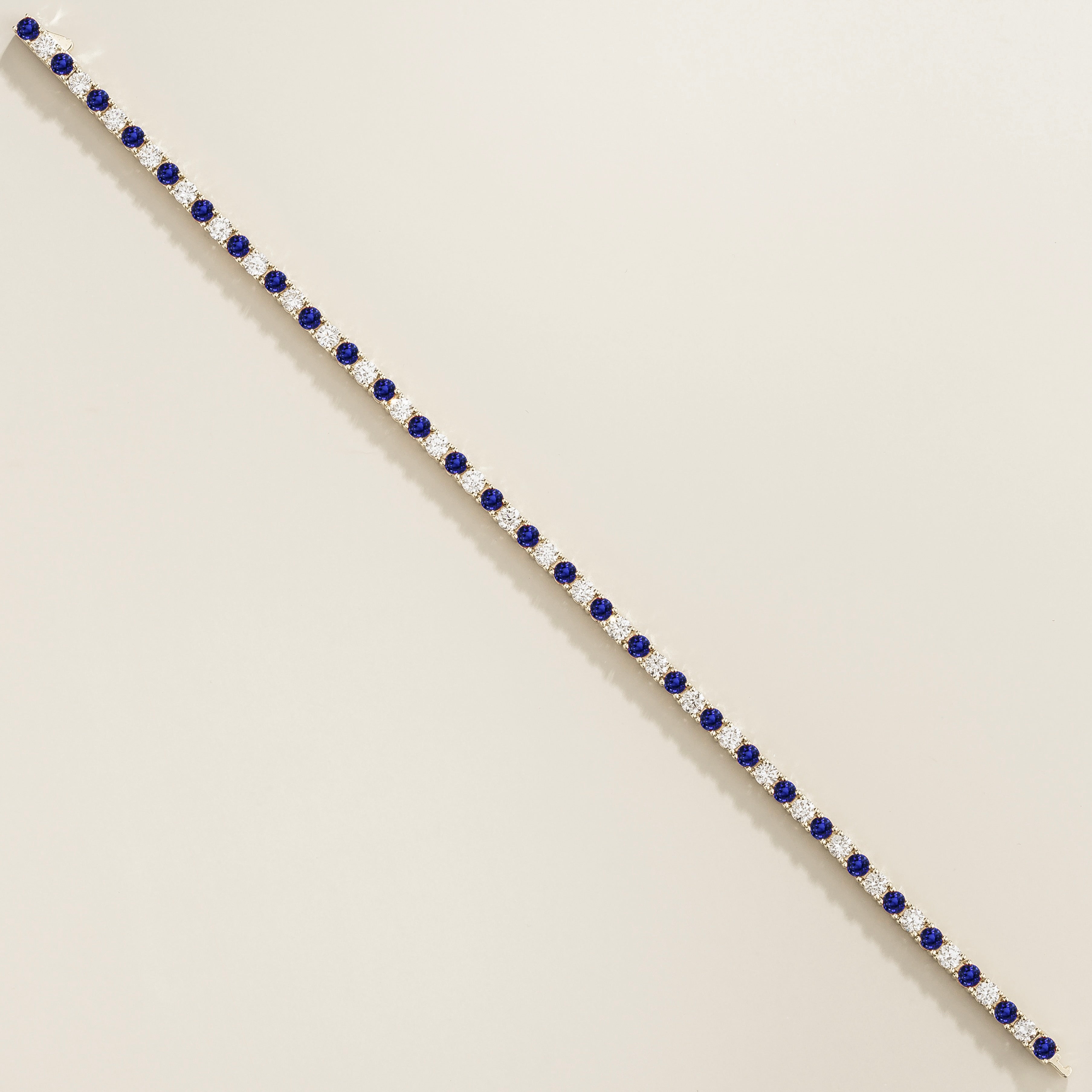 white gold bracelet featuring round blue sapphire gemstones and lab grown diamonds