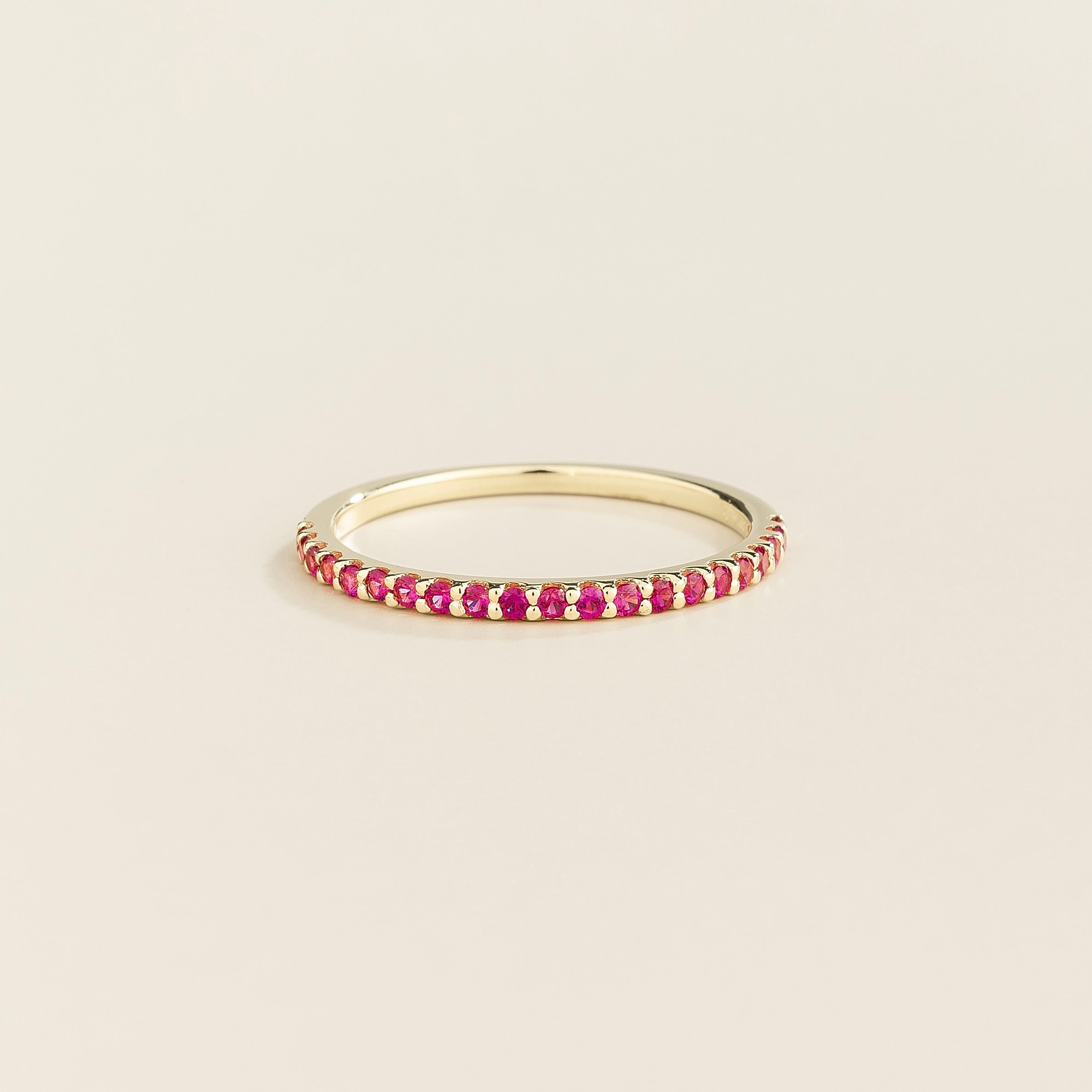 Juvetti white gold half eternity band set with round lab-grown ruby gemstones.