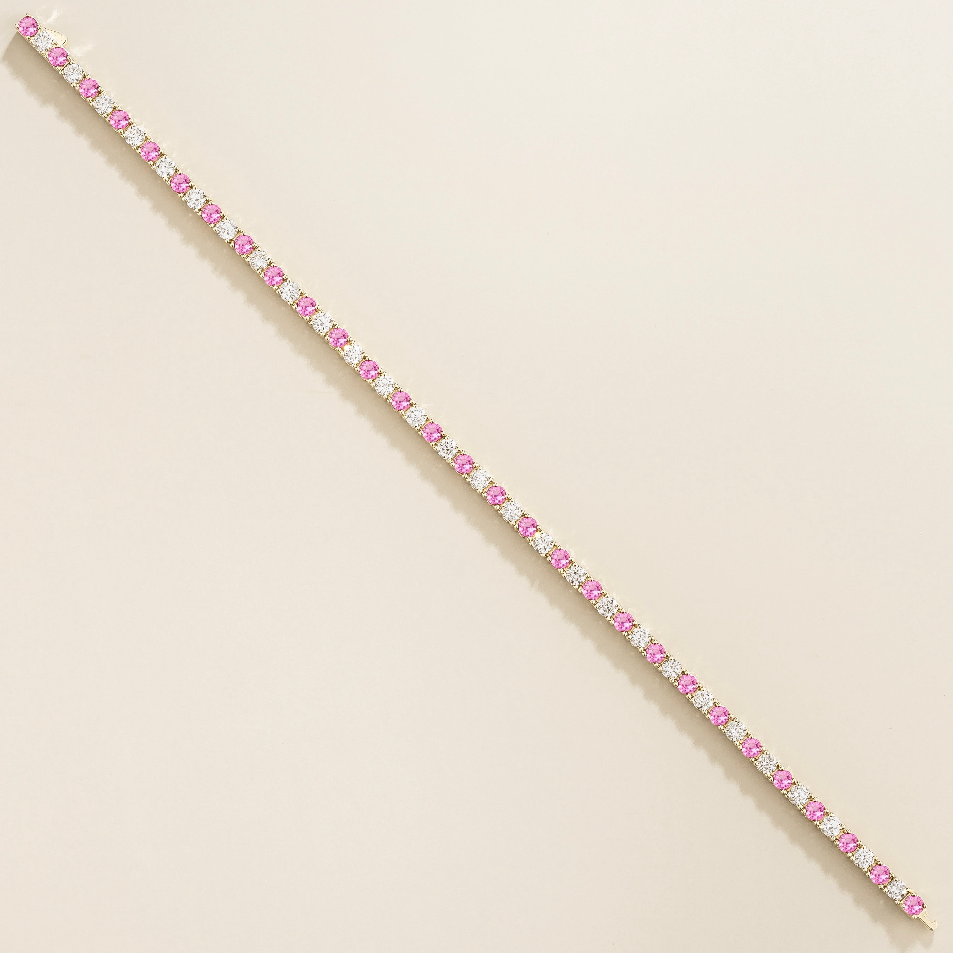 white gold bracelet featuring round pink sapphire gemstones and lab grown diamonds