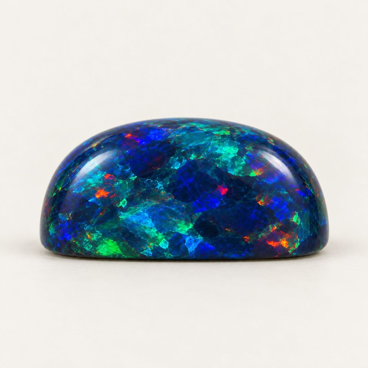 Black lab-grown opal, cushion cabochon, side view