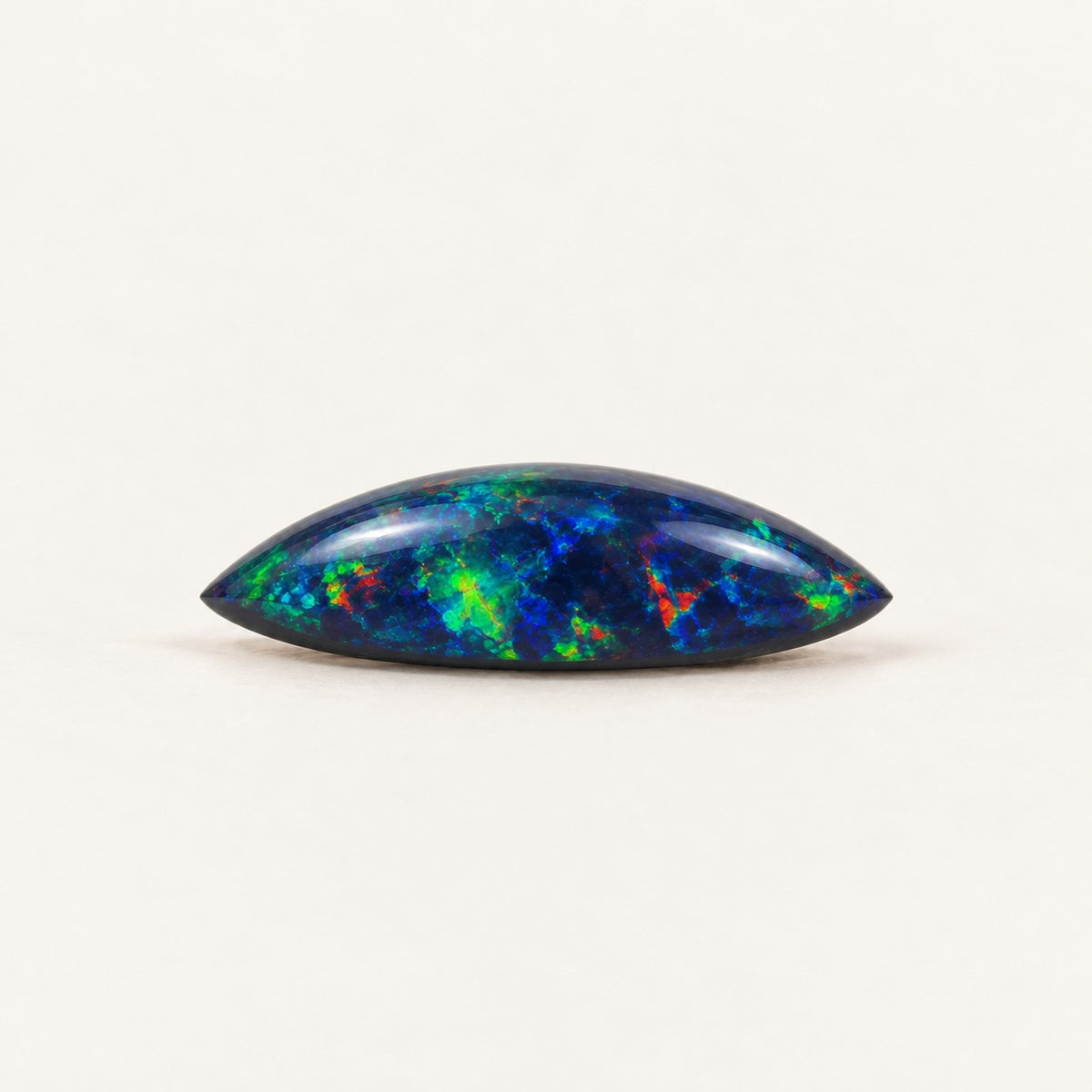 Black lab-grown opal, marquise cabochon, side view