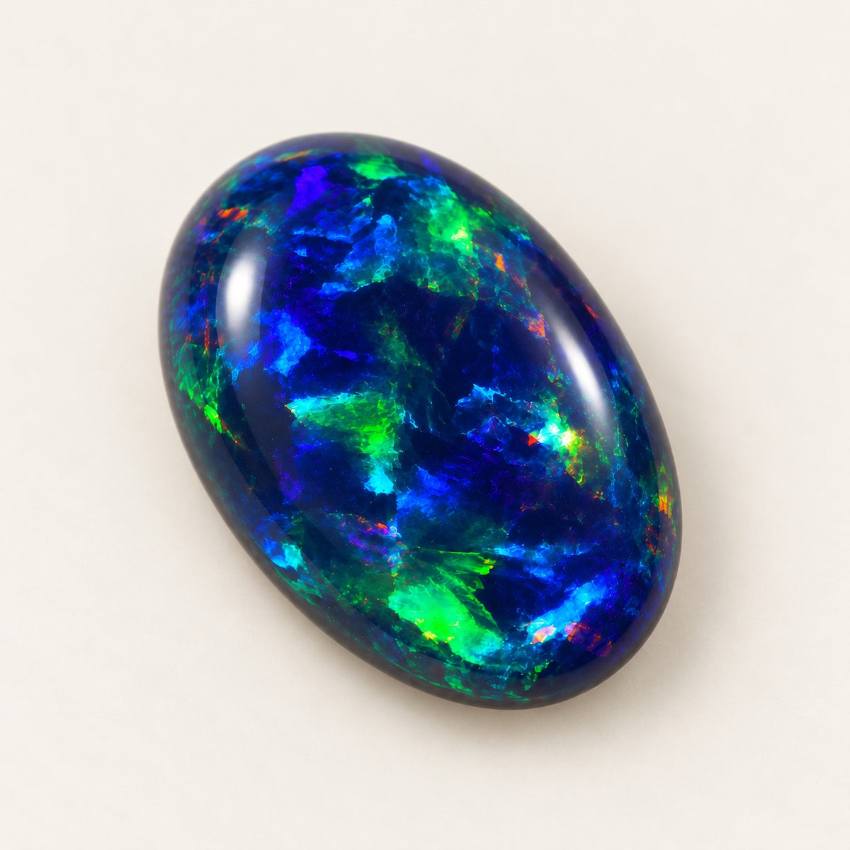 Black lab-grown opal, oval cabochon, 45° view