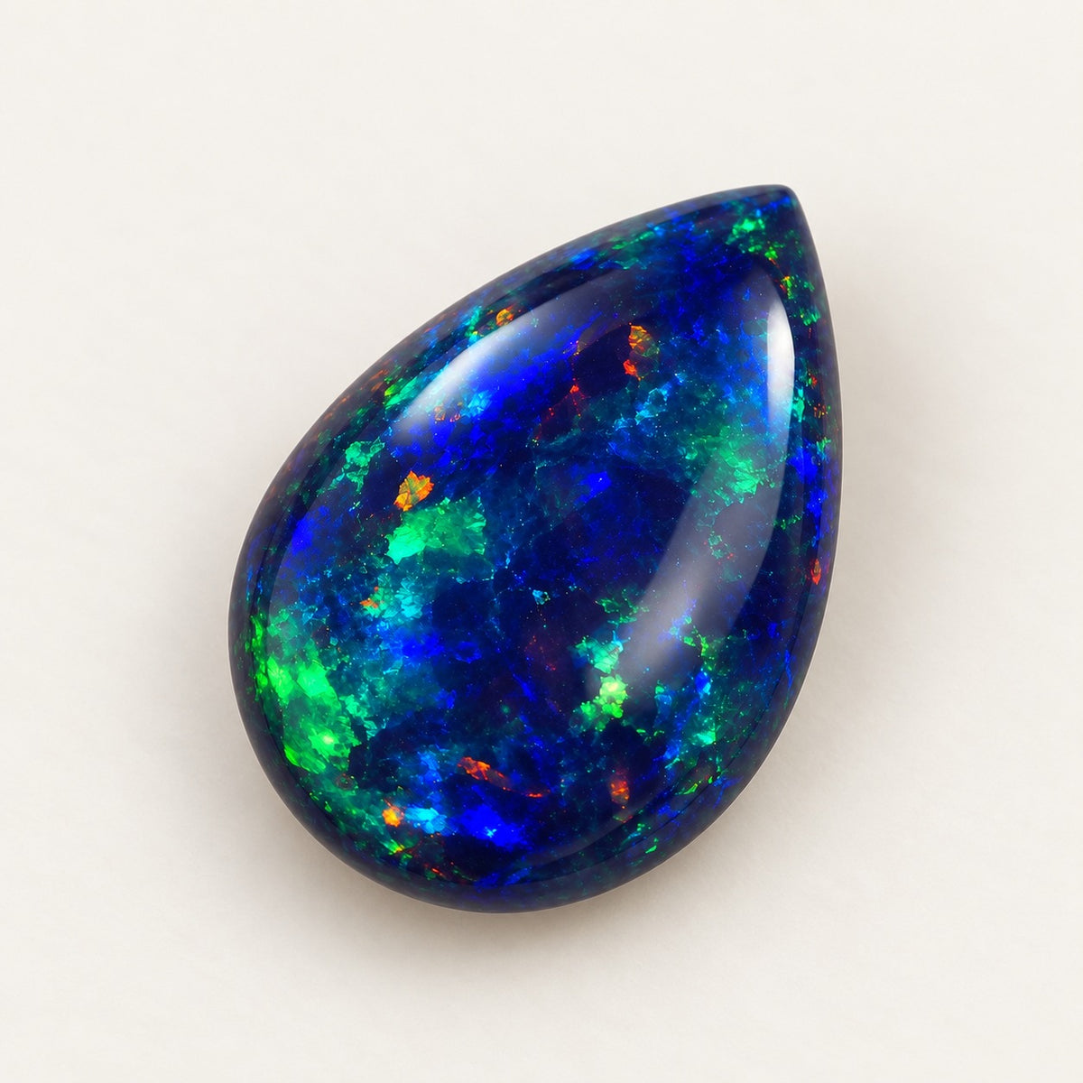 Black lab-grown opal, pear cabochon, 45° view