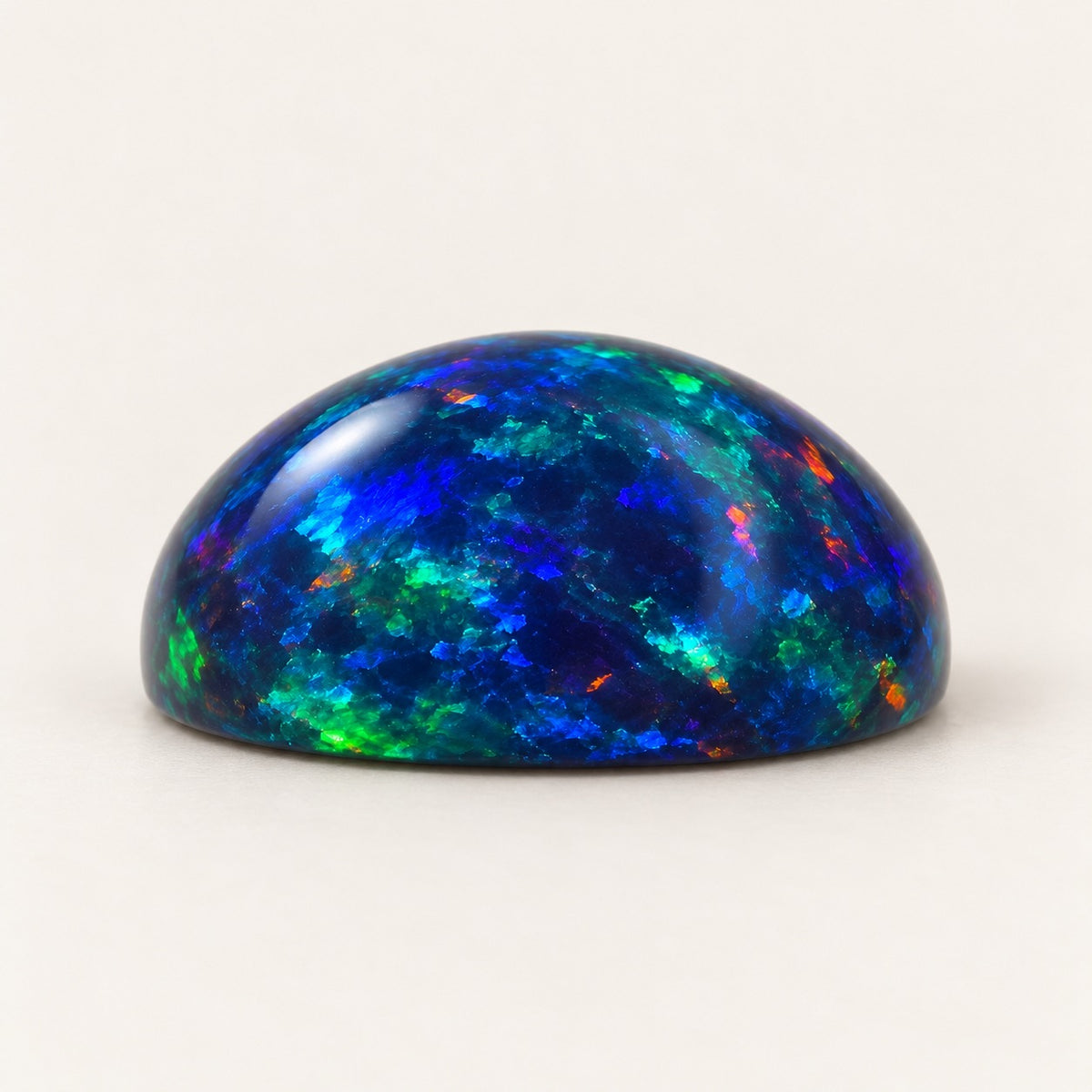 Black lab-grown opal, round cabochon, side view