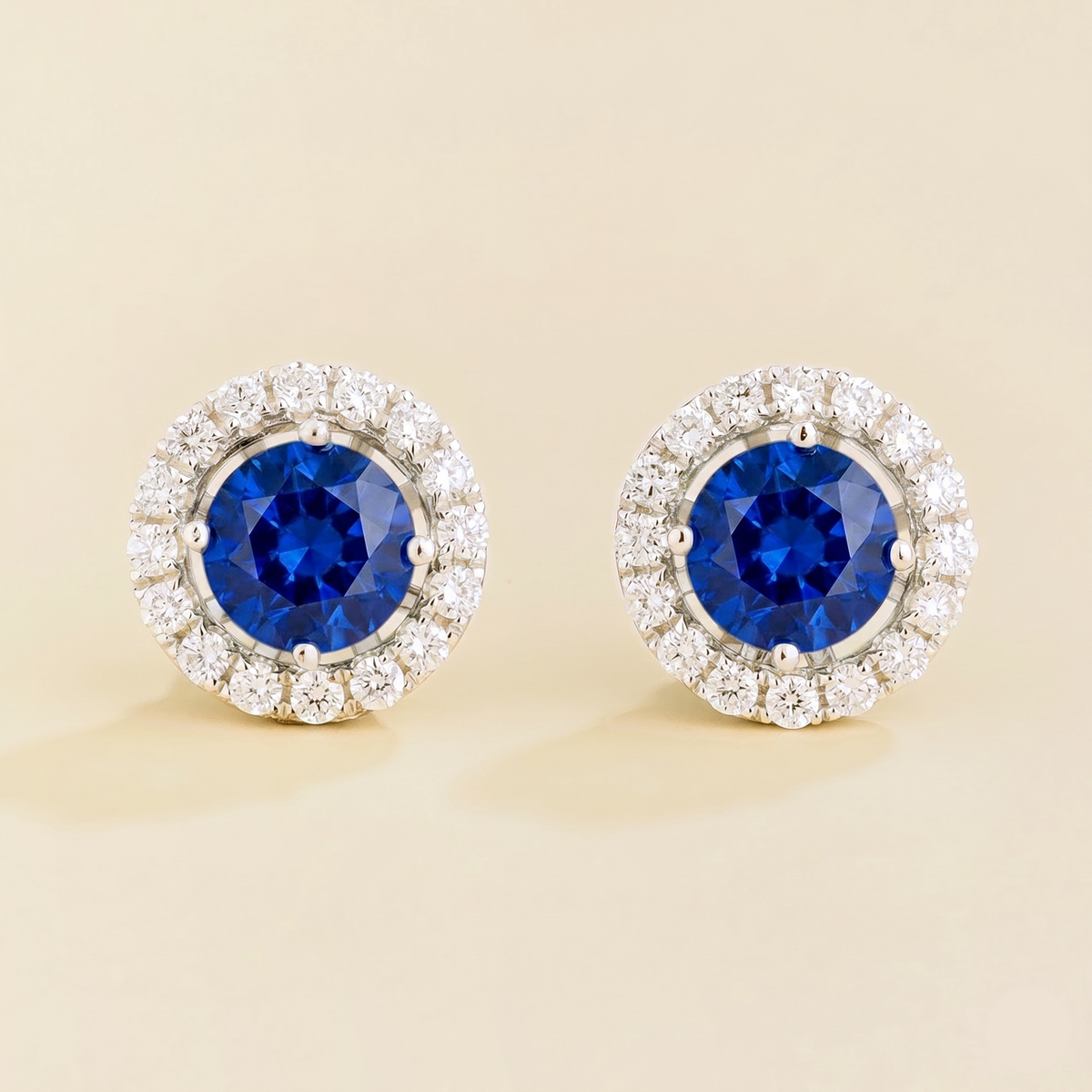 Floret round lab-grown blue sapphire and diamond halo stud earrings in white gold – front | Juvetti London