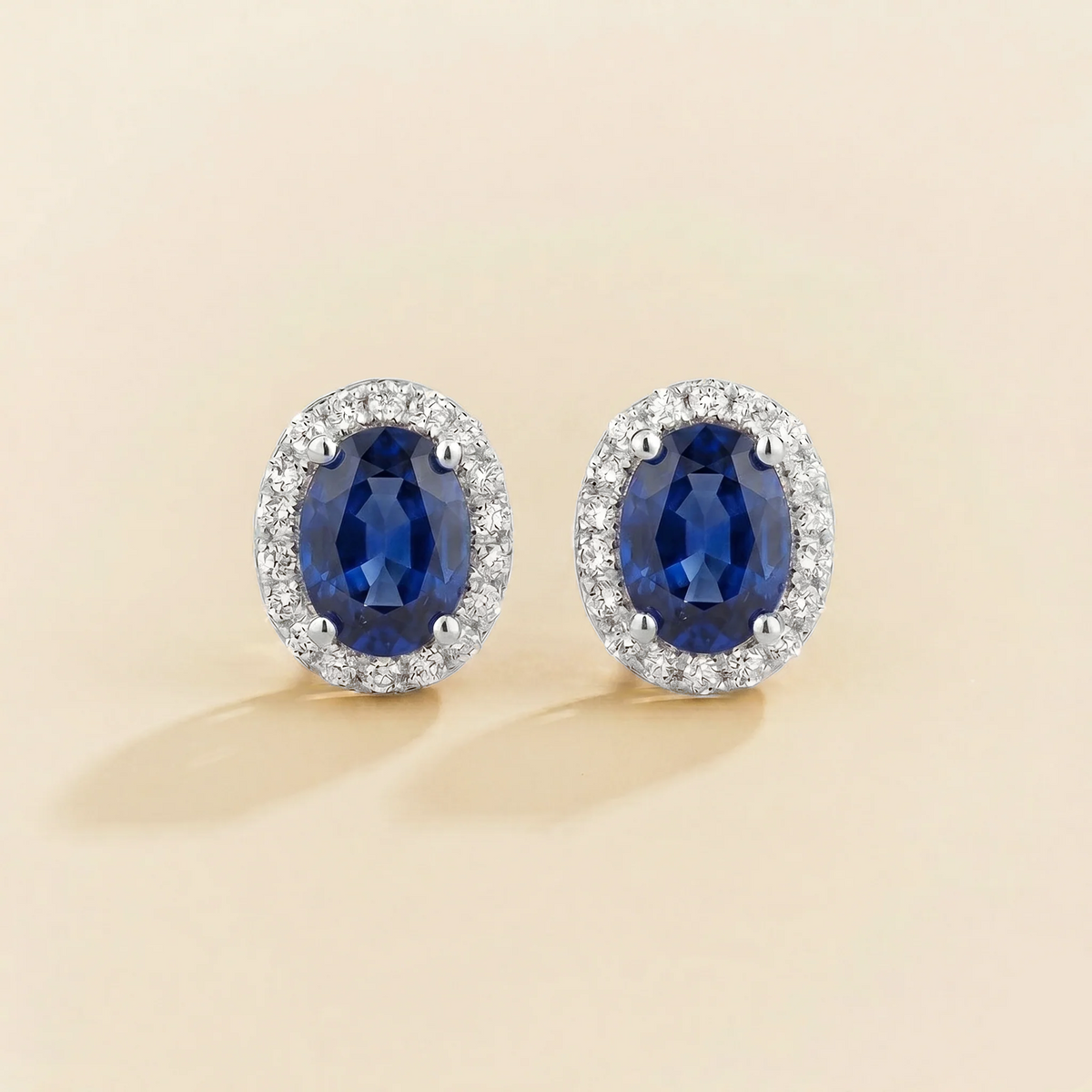 Lab-grown blue sapphire and diamond oval halo stud earrings in white gold – front view | Mina by Juvetti