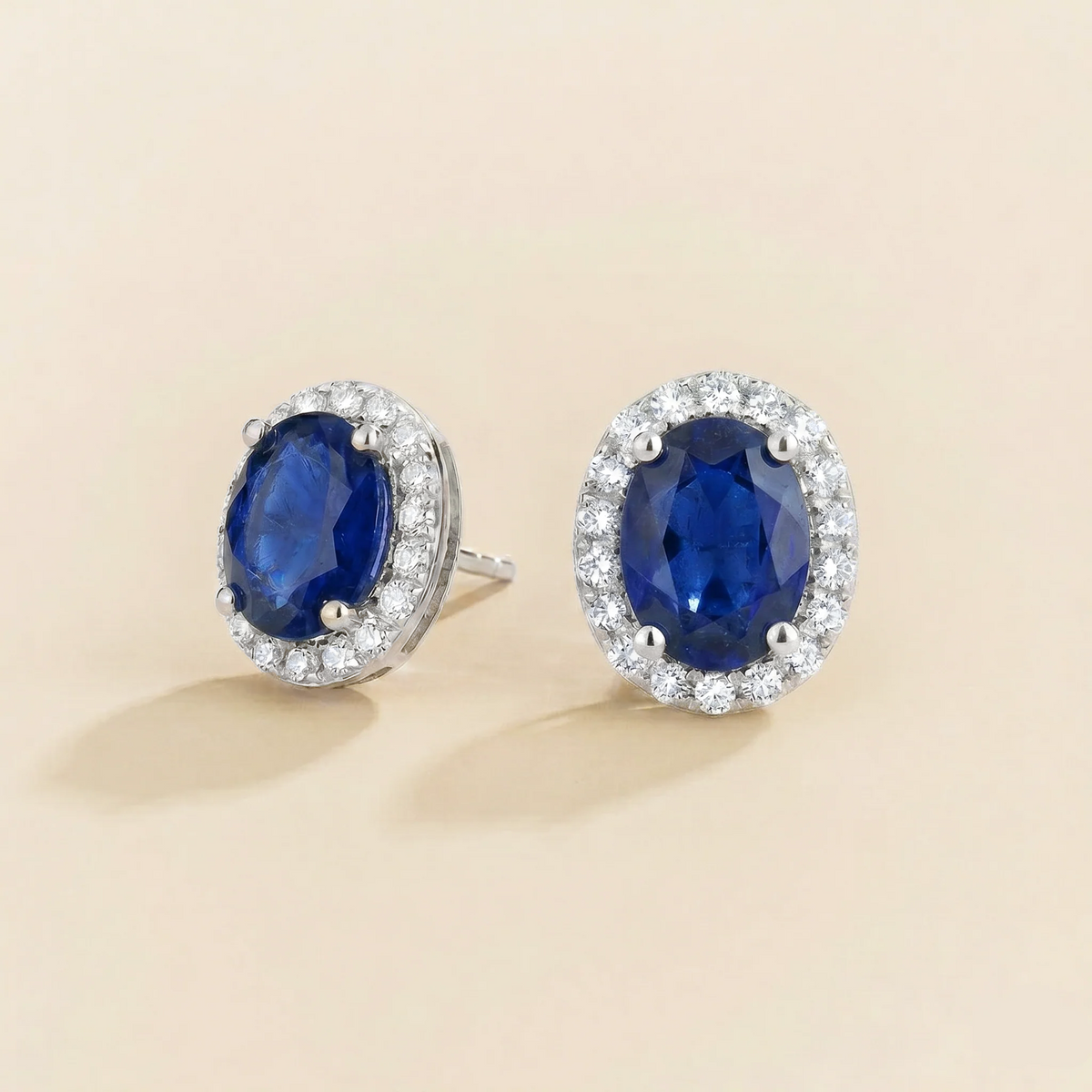 Lab-grown blue sapphire and diamond oval halo stud earrings in white gold – side view | Mina by Juvetti