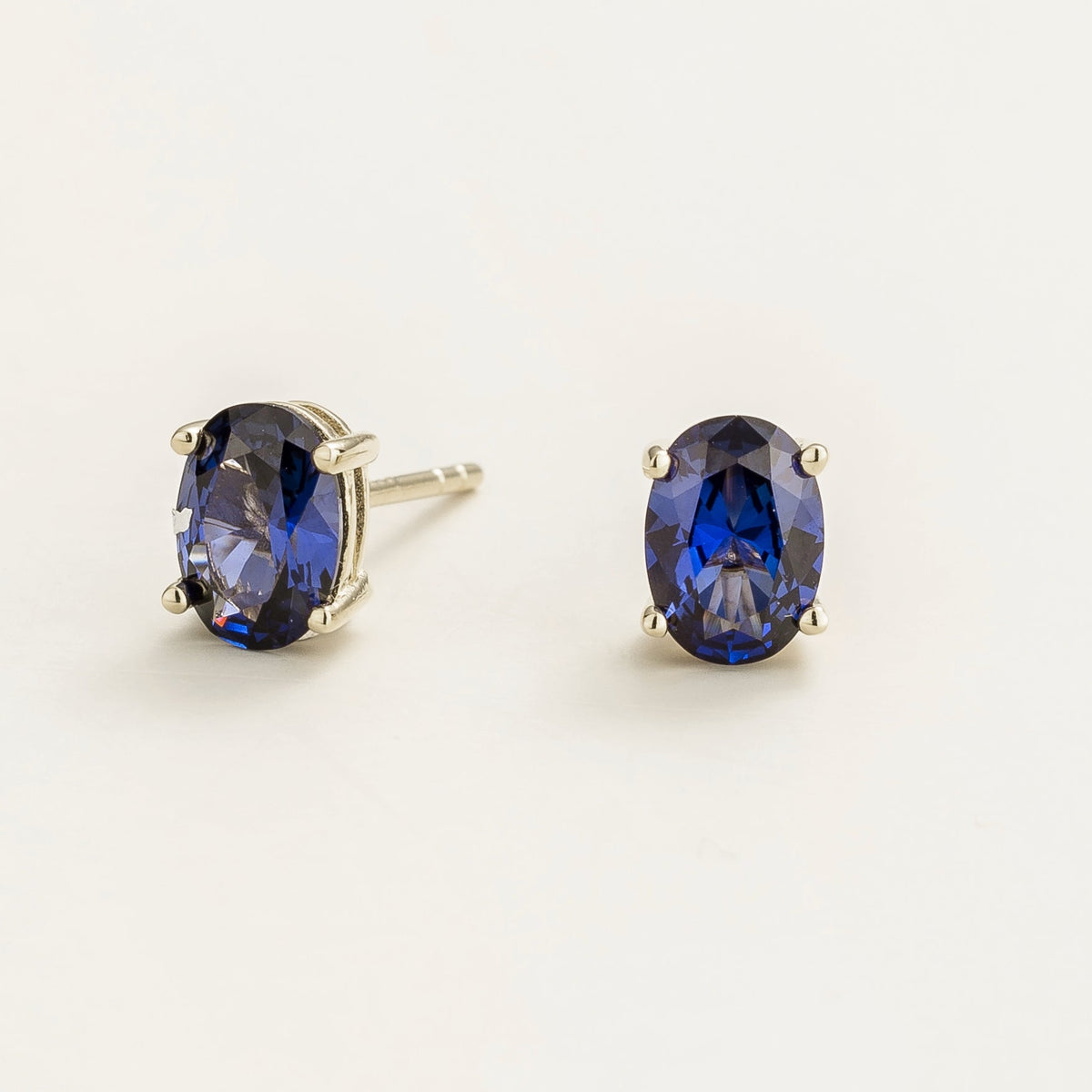 Ovo Blue Sapphire Oval Stud Earrings in White Gold – angle view