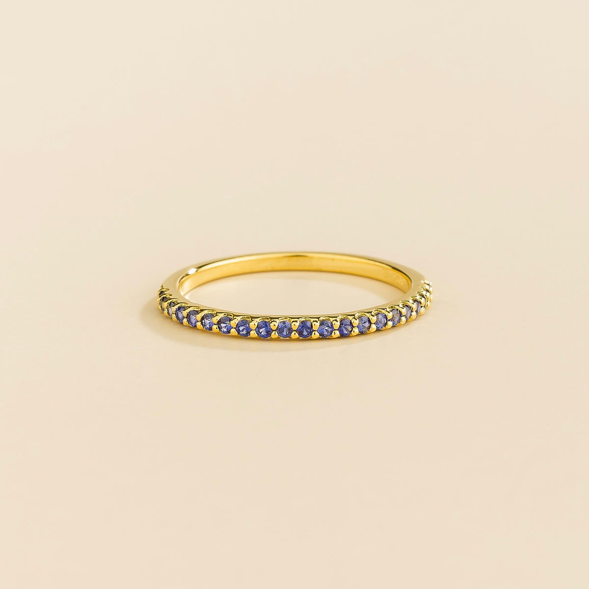 Stacy blue sapphire half eternity band in gold