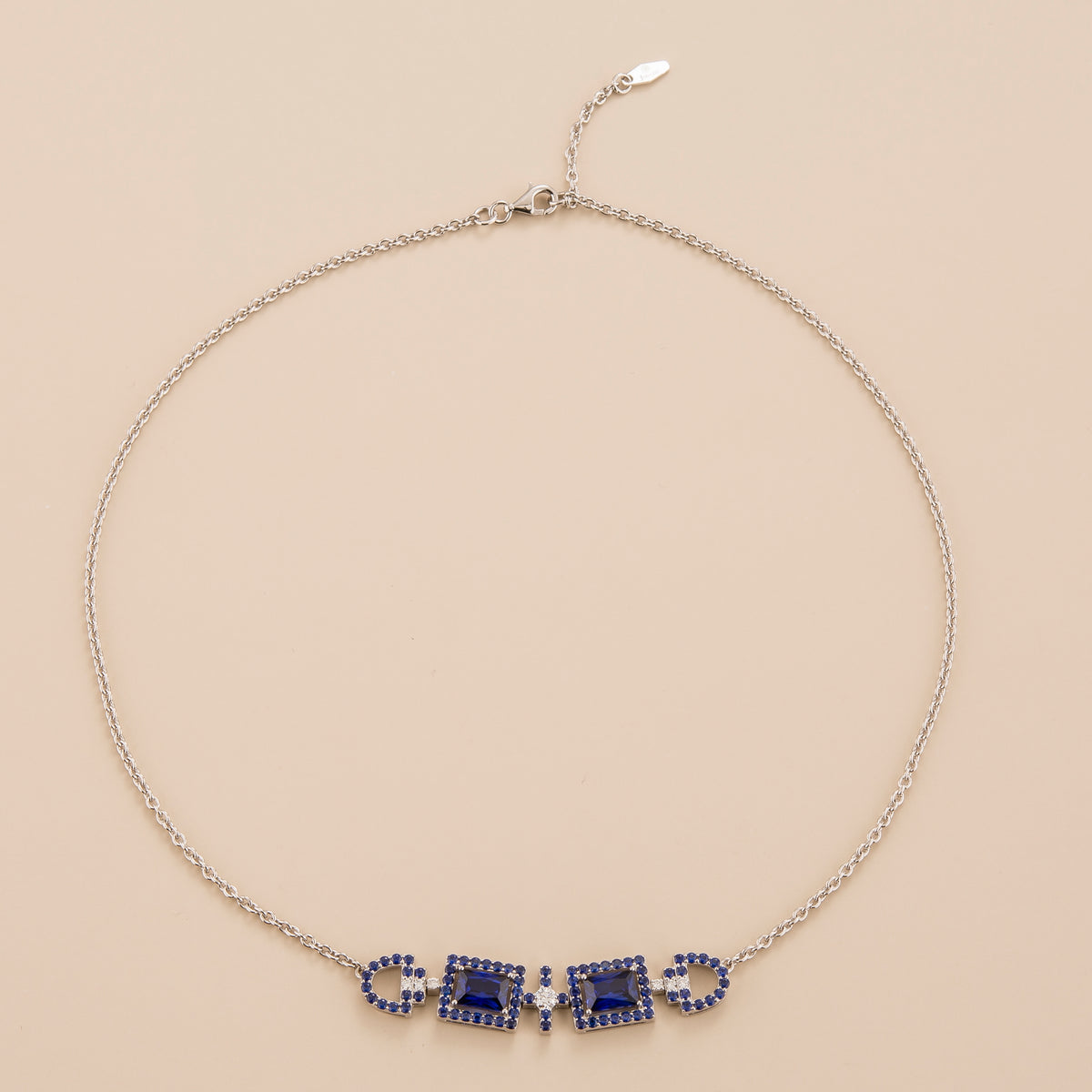 Ciceris blue sapphire Art Deco halo necklace in white gold, two emerald-cut lab-grown sapphires with diamonds, front view | Juvetti London