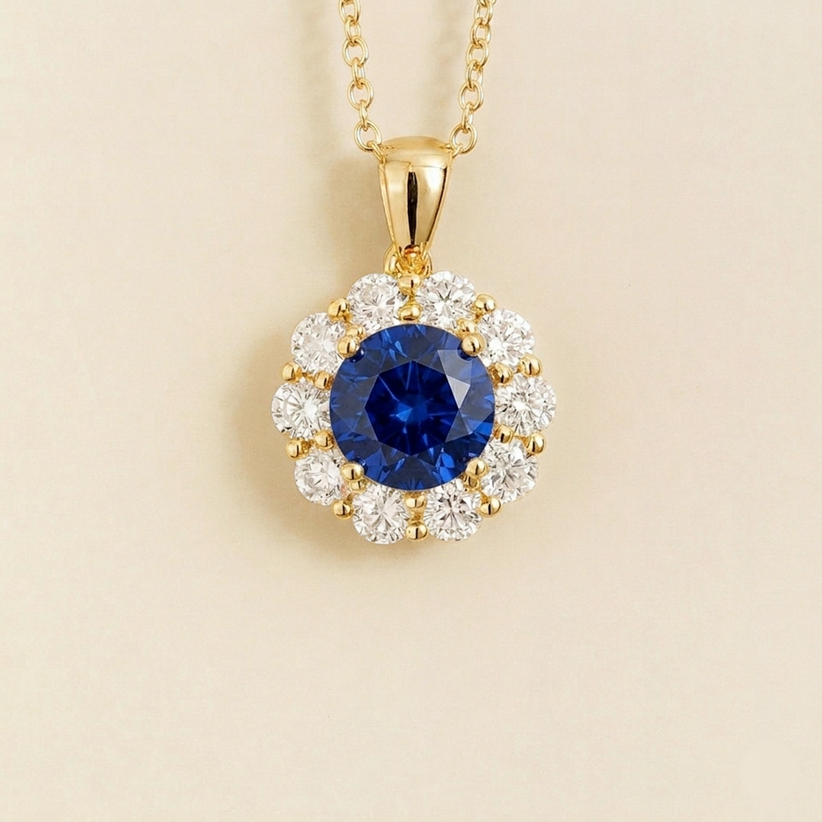 Floret round lab-grown blue sapphire and diamond halo pendant necklace in gold – front | Juvetti London