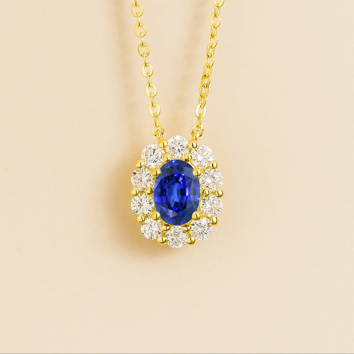 Prill Blue Sapphire Oval & Diamond Halo Pendant Necklace in Gold | Juvetti