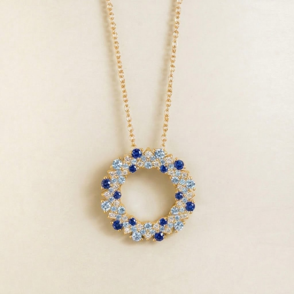 Starry blue sapphire and diamond eternity circle pendant necklace in gold, front view