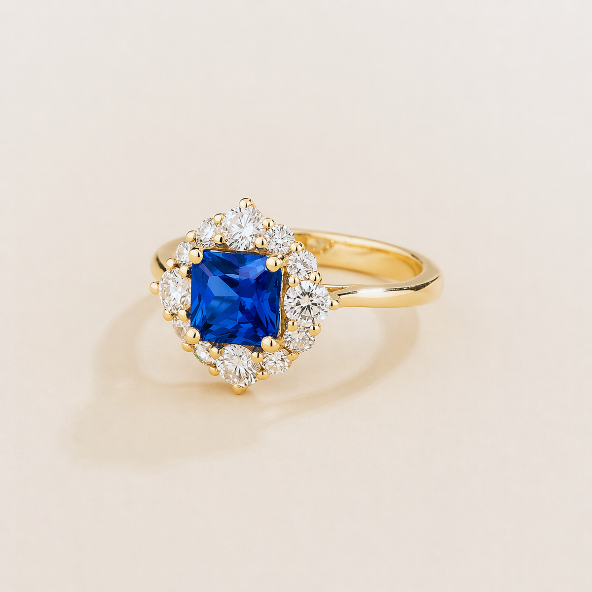 Tuli cushion-cut lab-grown blue sapphire and diamond halo ring in gold – angle view | Juvetti London