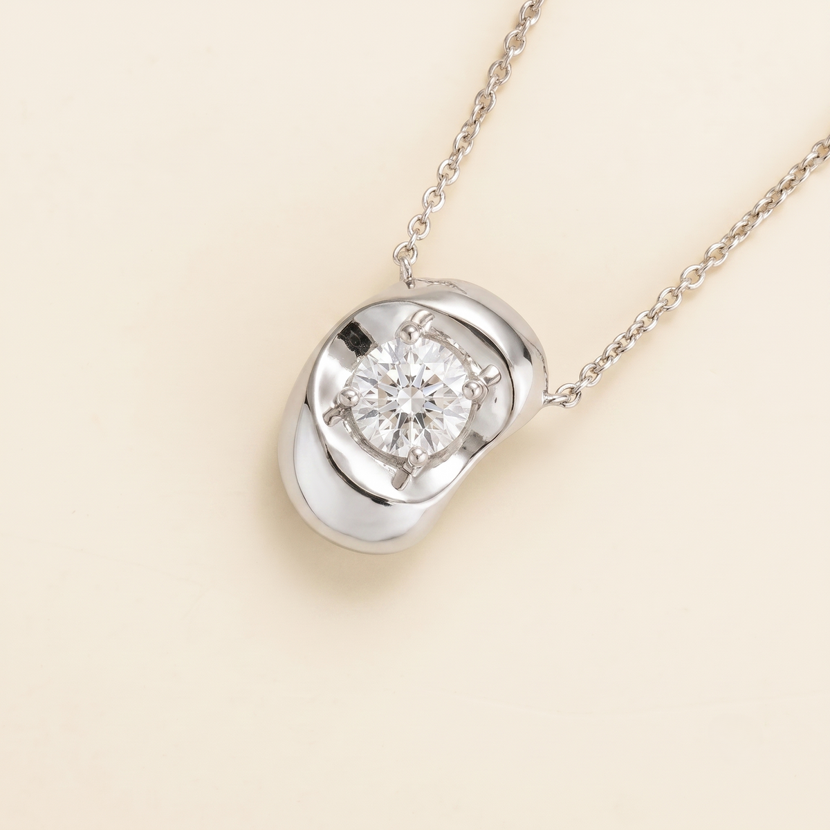 Fava round lab-grown diamond pendant necklace in white gold, sculpted pebble setting, angled view | Juvetti London