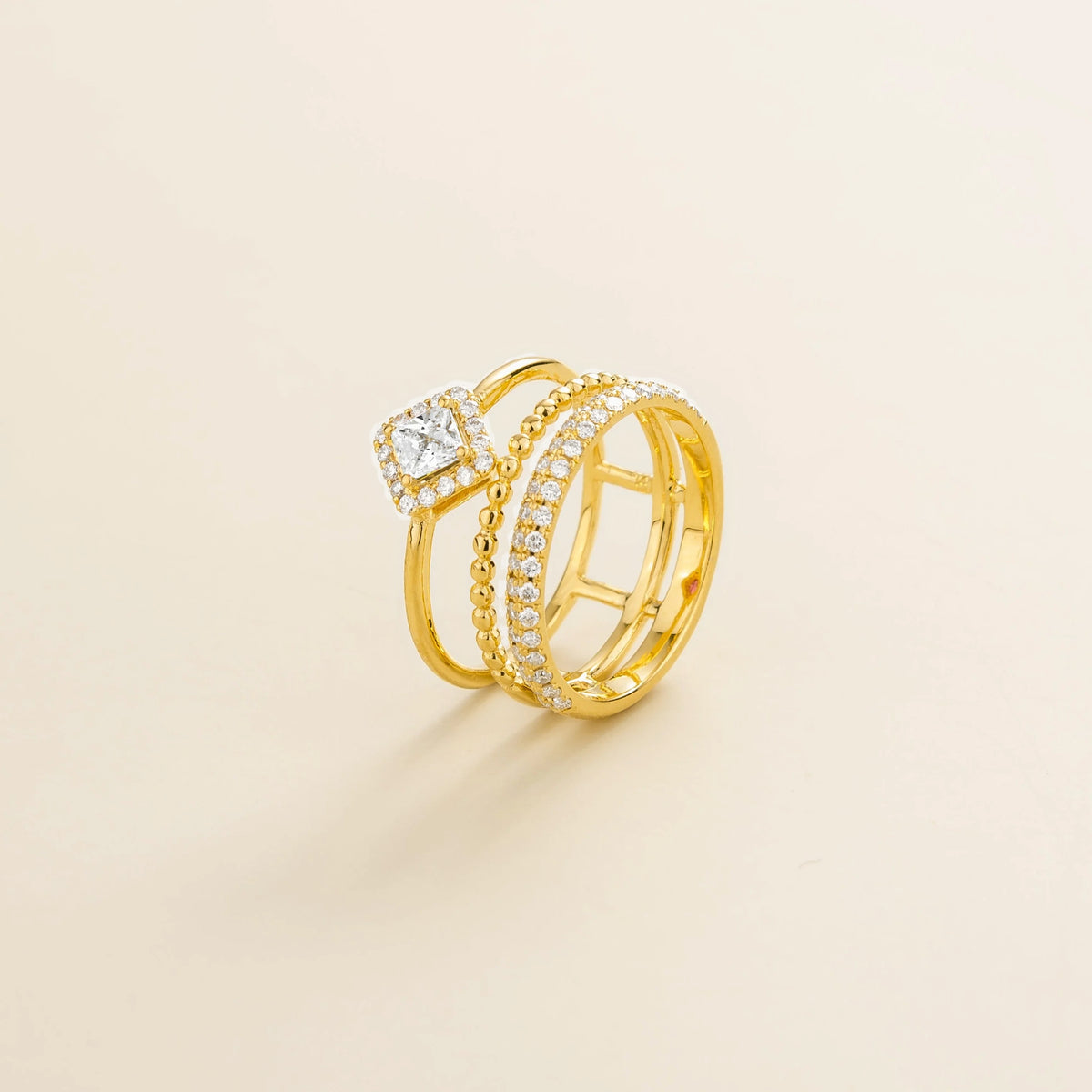 Amici triple-band stacking ring in gold, princess-cut lab-grown diamond in a diamond halo with beaded and pavé bands, side view | Juvetti London