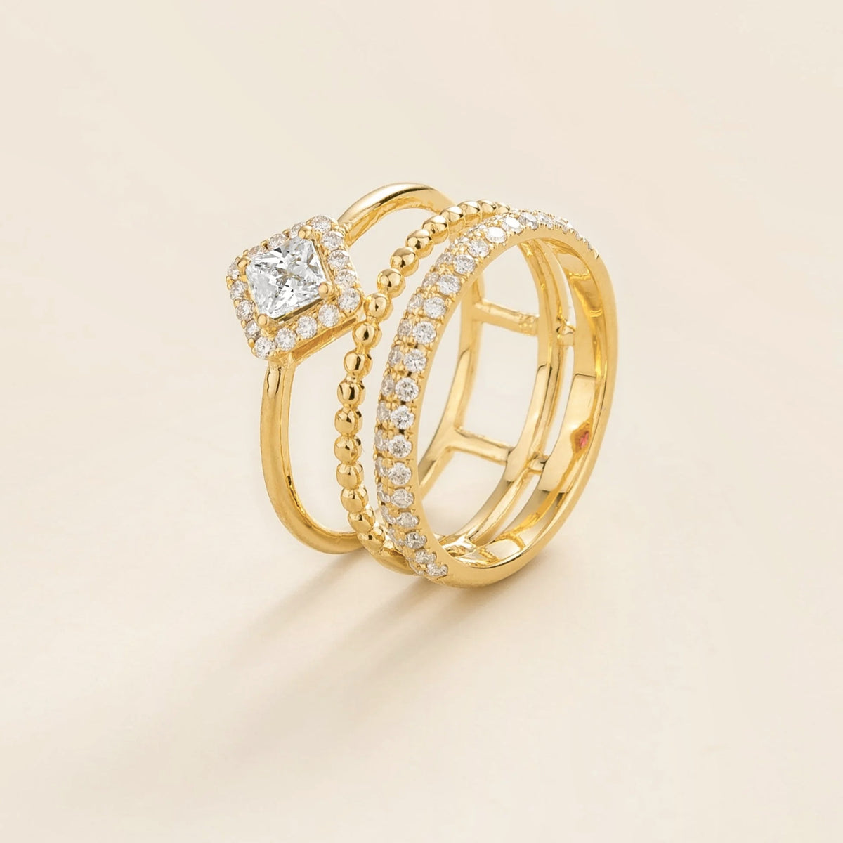 Amici triple-band stacking ring in gold, princess-cut lab-grown diamond in a diamond halo with beaded and pavé bands, side view | Juvetti London