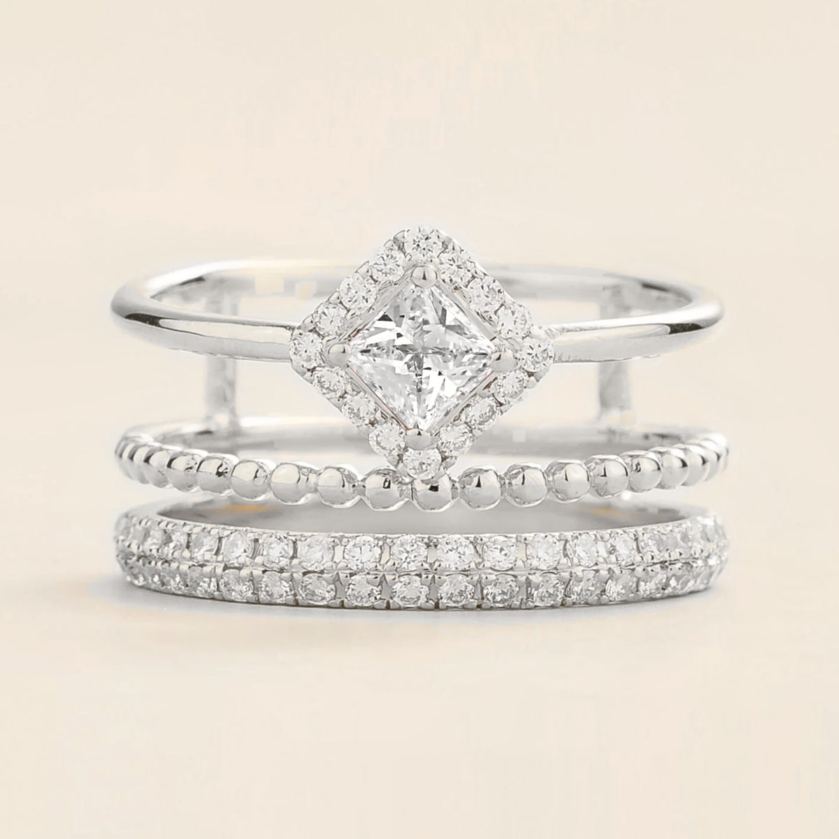 Amici triple-band stacking ring in white gold, princess-cut lab-grown diamond in a diamond halo with beaded and pavé bands, front view | Juvetti London