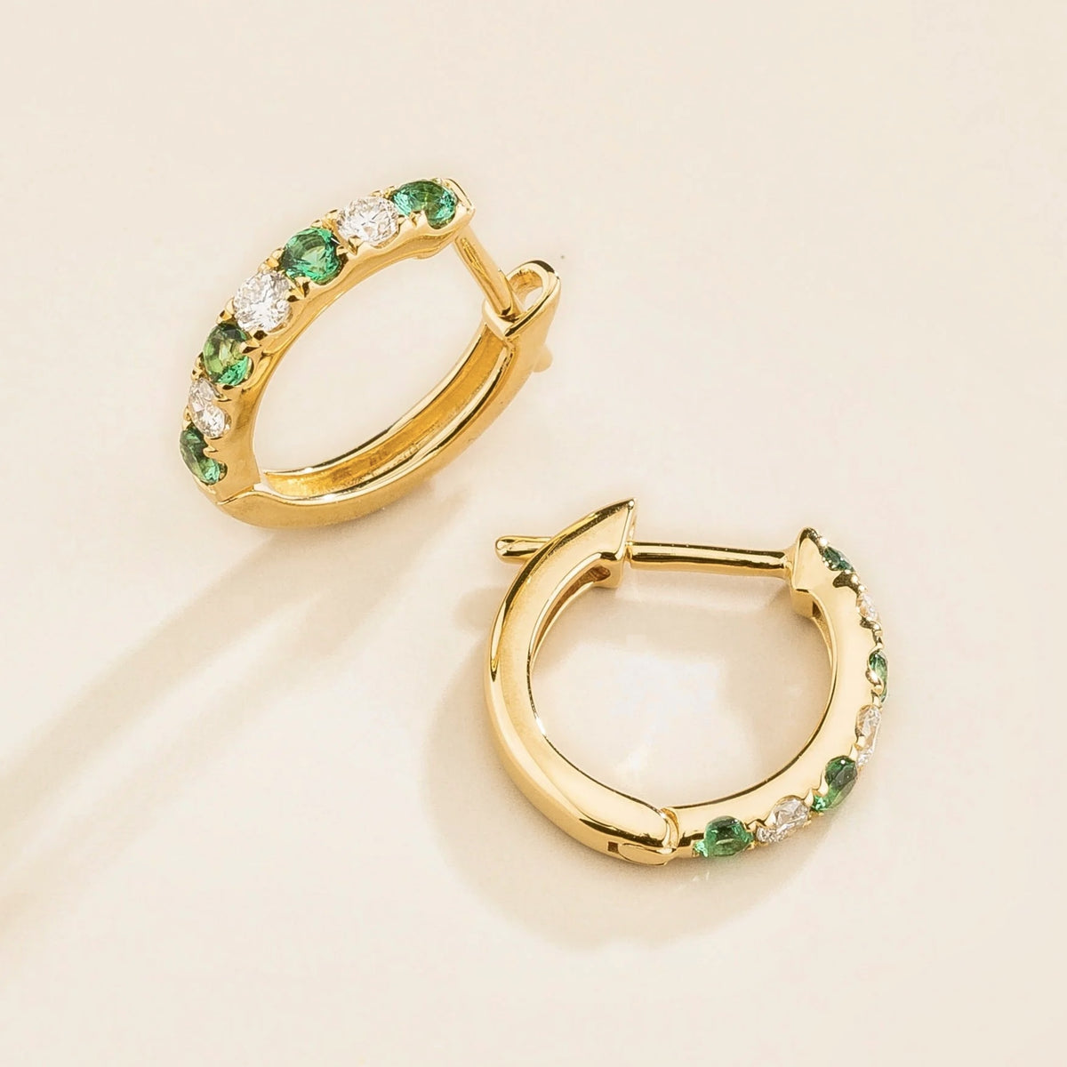 Stacy Emerald & Diamond Huggie Hoop Earrings in Gold – angle view