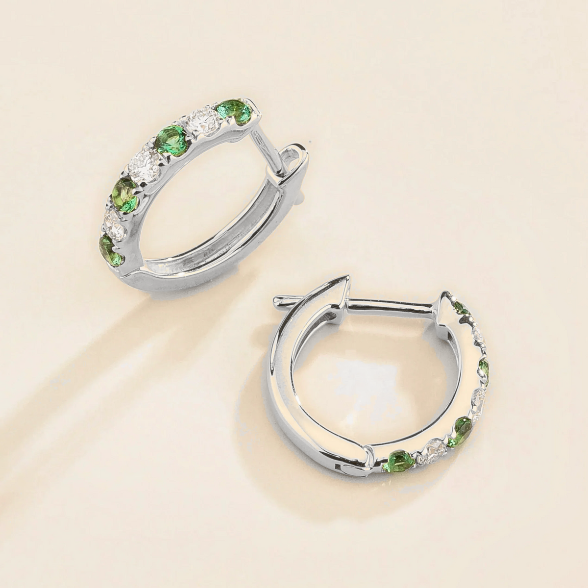 Stacy Emerald & Diamond Huggie Hoop Earrings in White Gold – angle view