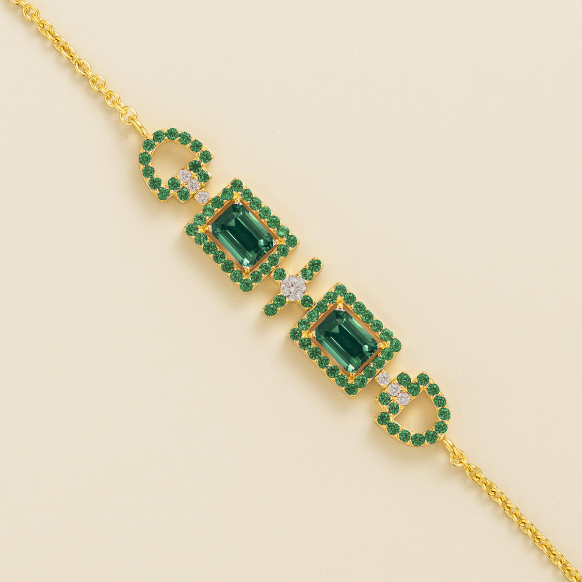 Ciceris emerald Art Deco halo bracelet in gold, two emerald-cut lab-grown emeralds with diamonds, close-up | Juvetti London