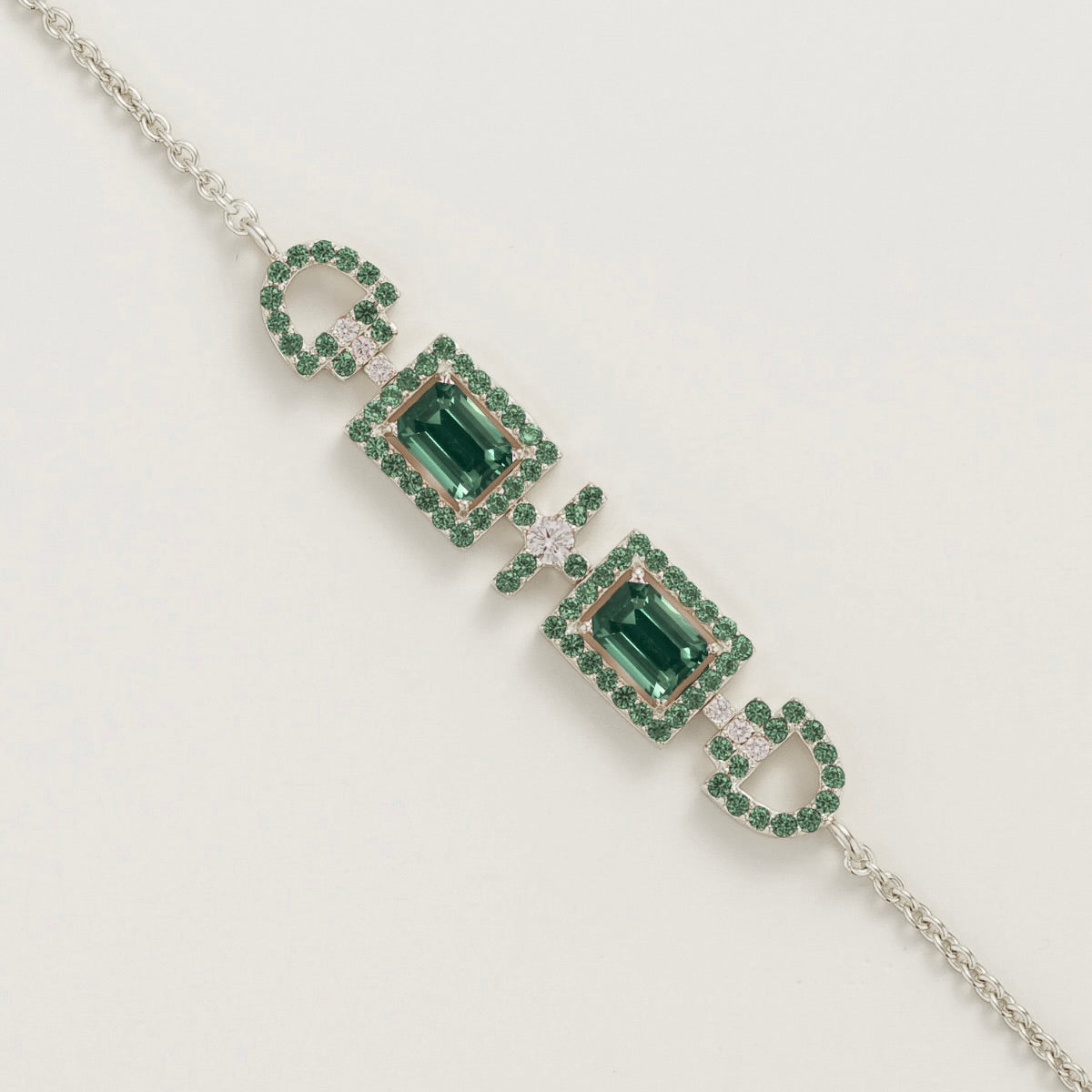 Ciceris emerald Art Deco halo bracelet in white gold, two emerald-cut lab-grown emeralds with diamonds, close-up | Juvetti London