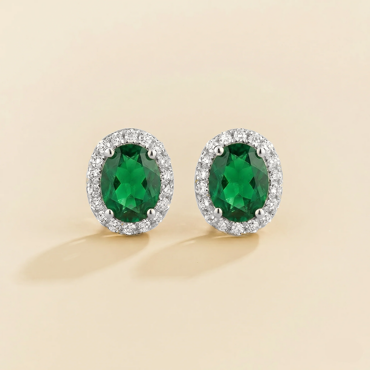 Lab-grown emerald and diamond oval halo stud earrings in white gold – front view | Mina by Juvetti