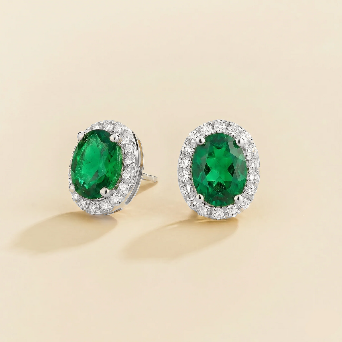 Lab-grown emerald and diamond oval halo stud earrings in white gold – side view | Mina by Juvetti