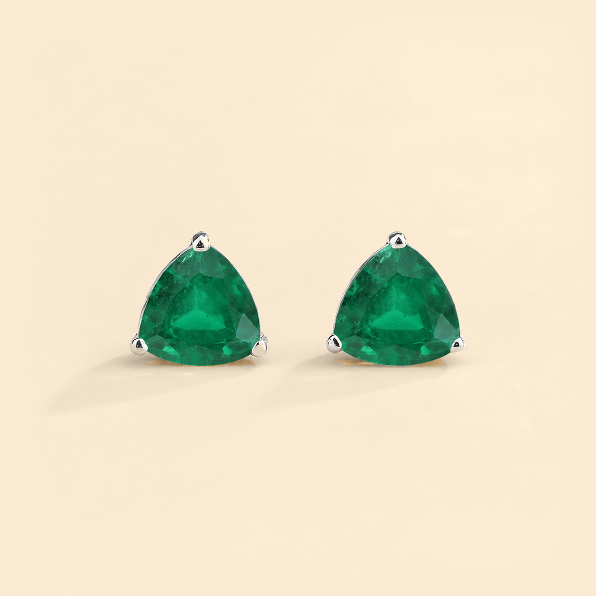Trillion emerald solitaire stud earrings in white gold
