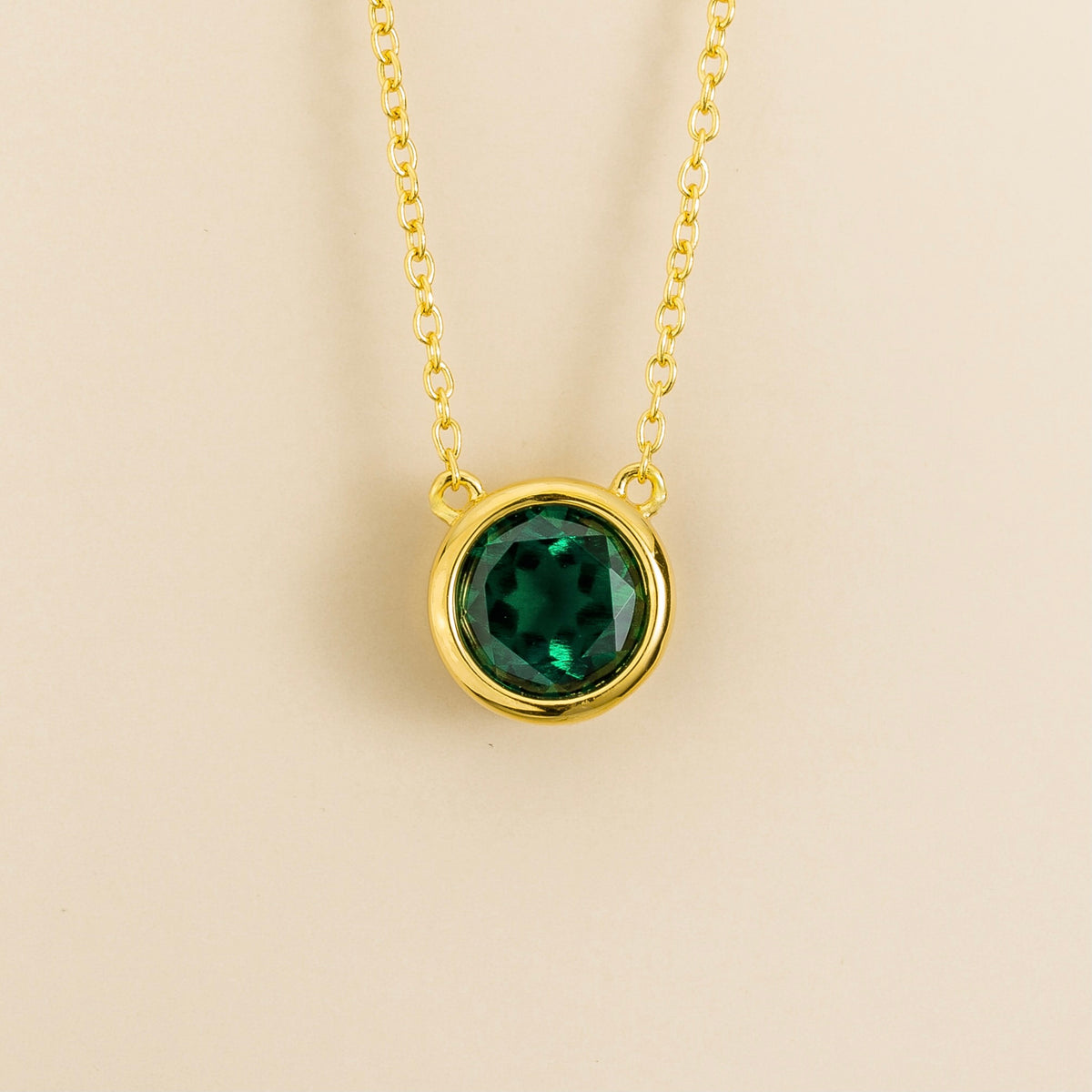 Margo emerald round bezel set solitaire necklace in gold