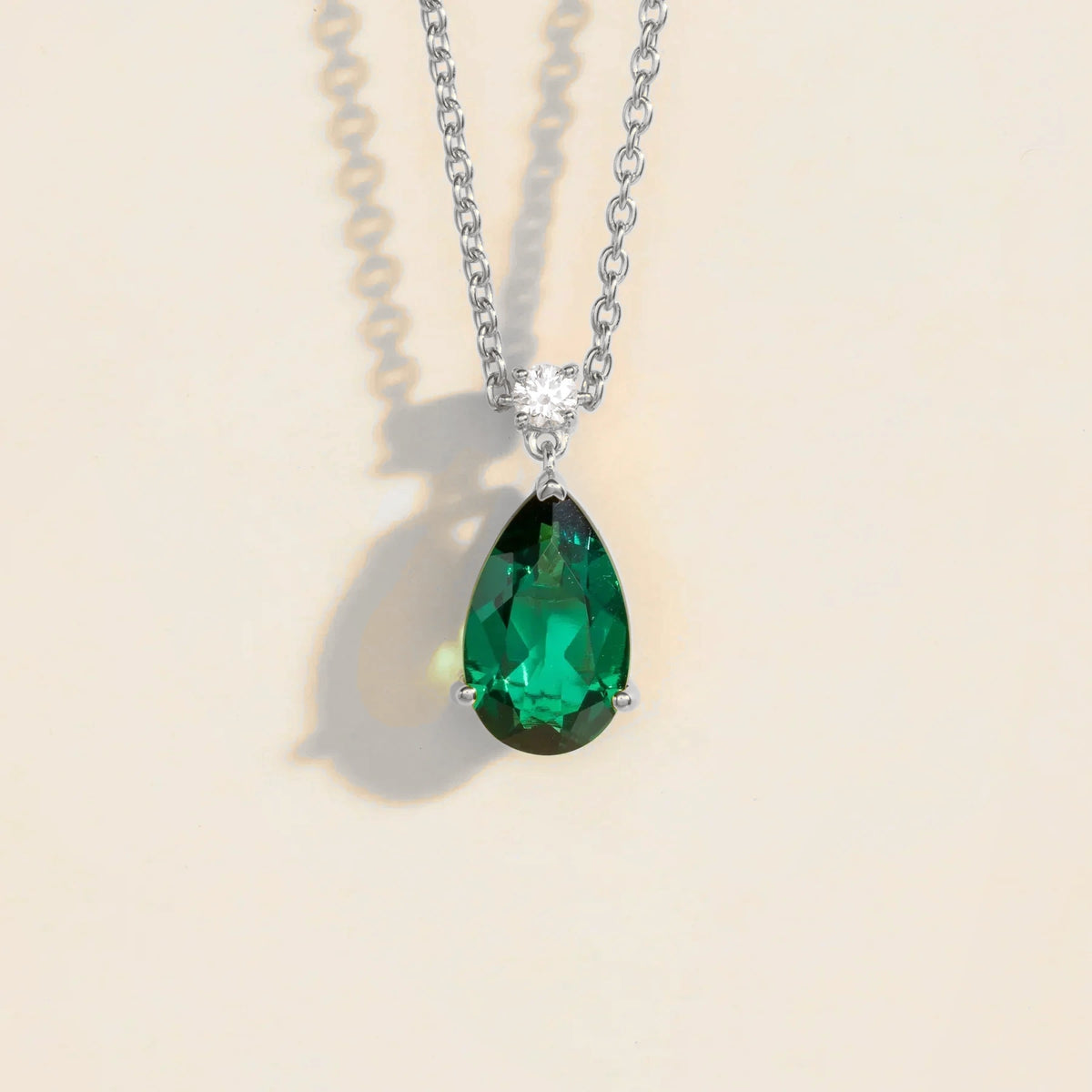 Lab-grown emerald and diamond pear drop pendant necklace in white gold, large – front view | Pisa by Juvetti