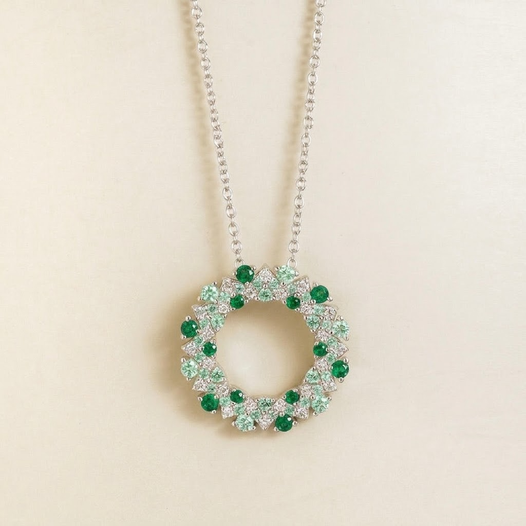 Starry emerald, green sapphire and diamond eternity circle pendant necklace in white gold, front view
