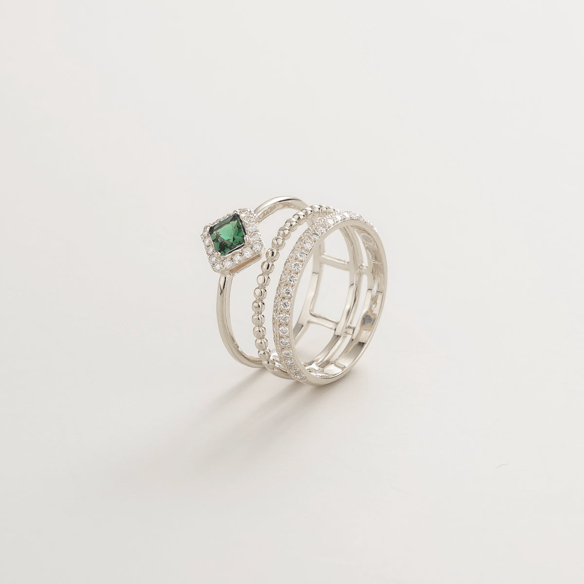 Amici triple-band stacking ring in white gold, princess-cut lab-grown emerald in a diamond halo with beaded and pavé bands, front view | Juvetti London