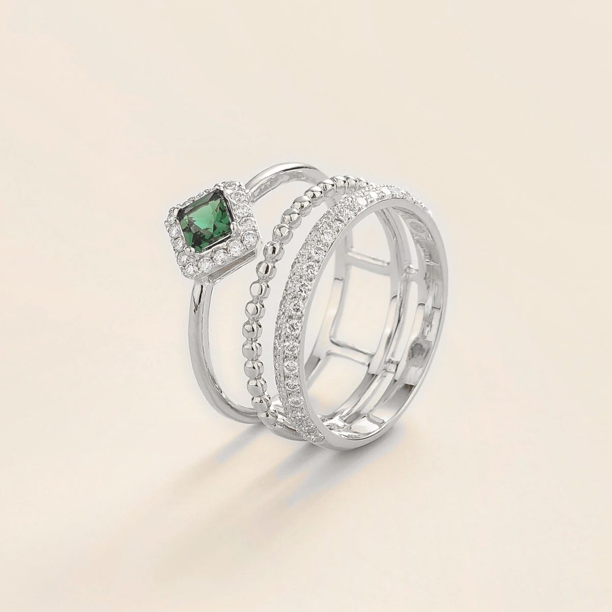 Amici triple-band stacking ring in white gold, princess-cut lab-grown emerald in a diamond halo with beaded and pavé bands, front view | Juvetti London