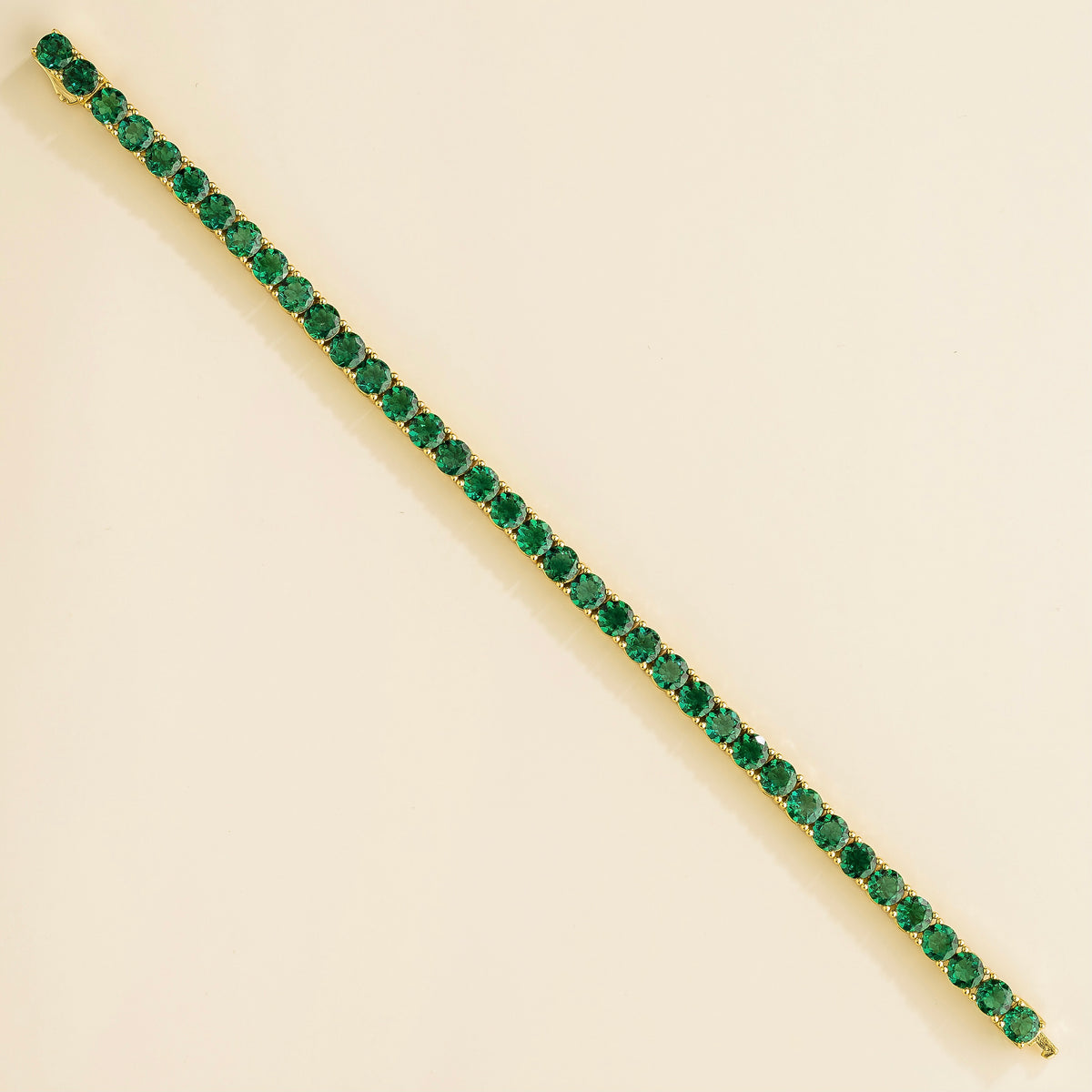 Round Emerald Tennis Bracelet in Gold – front view