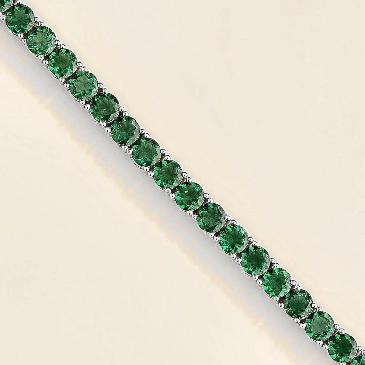 Round Emerald Tennis Bracelet in White Gold – front view