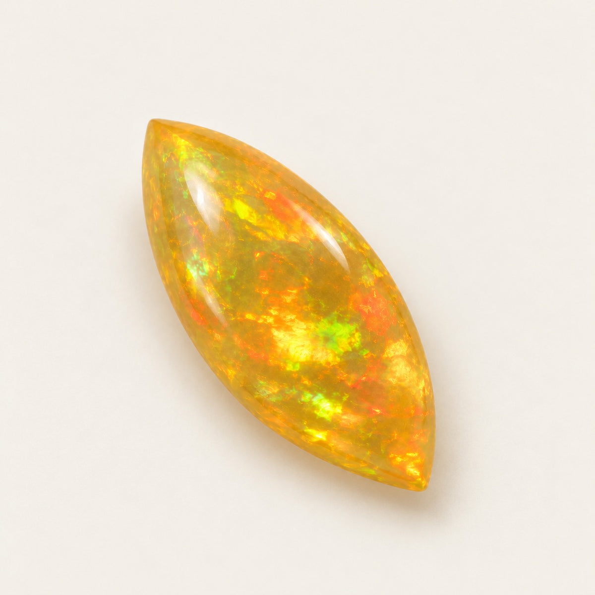Fire lab-grown opal, marquise cabochon, 45° view
